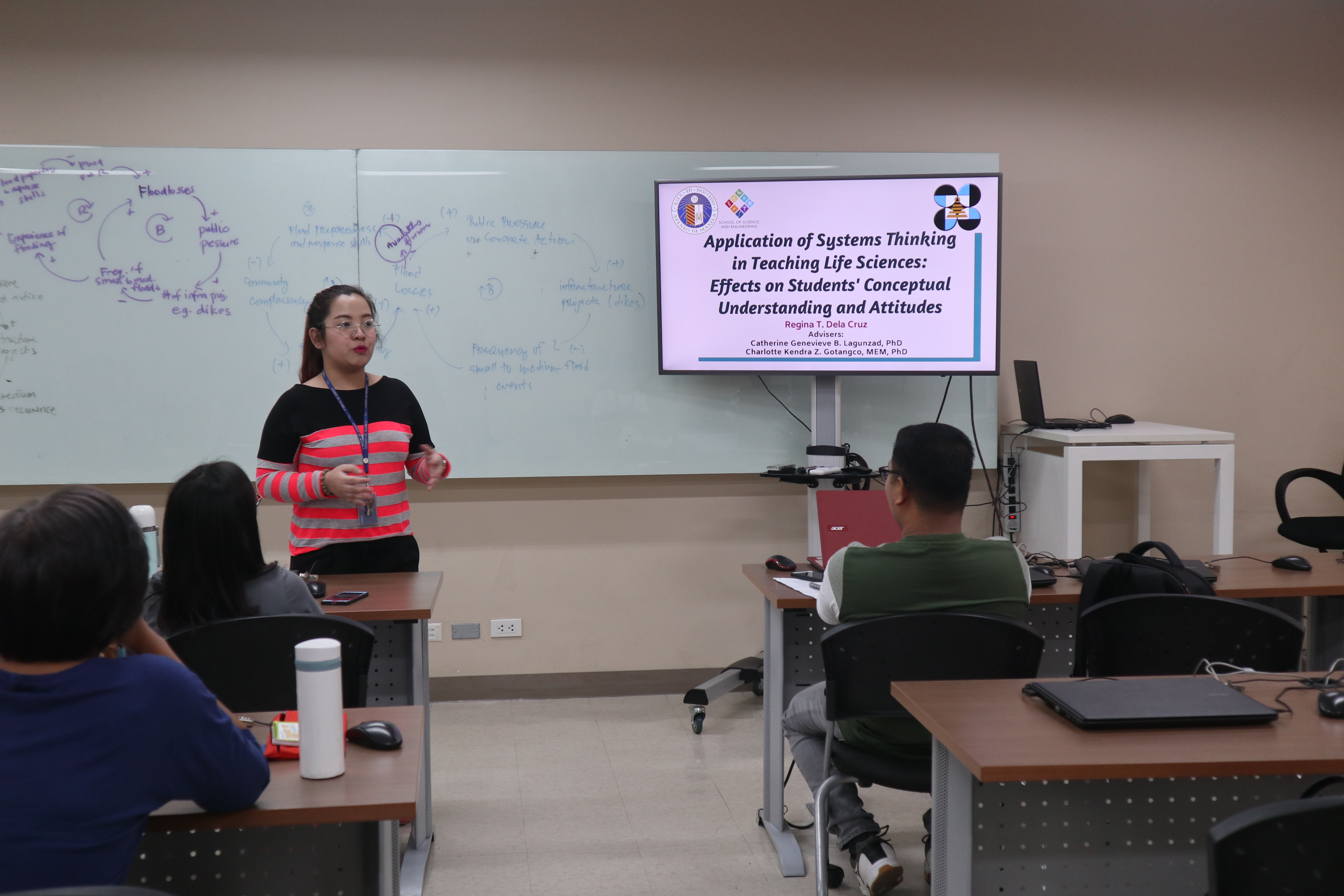 MS Science Education student Ms. Regina dela Cruz presenting sharing her thesis on applying systems thinking in the classroom
