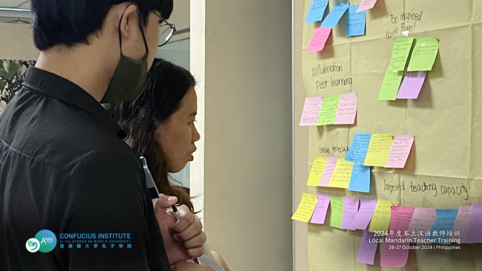 Training participants browsing through Community Wall Intentions accomplished during day 1