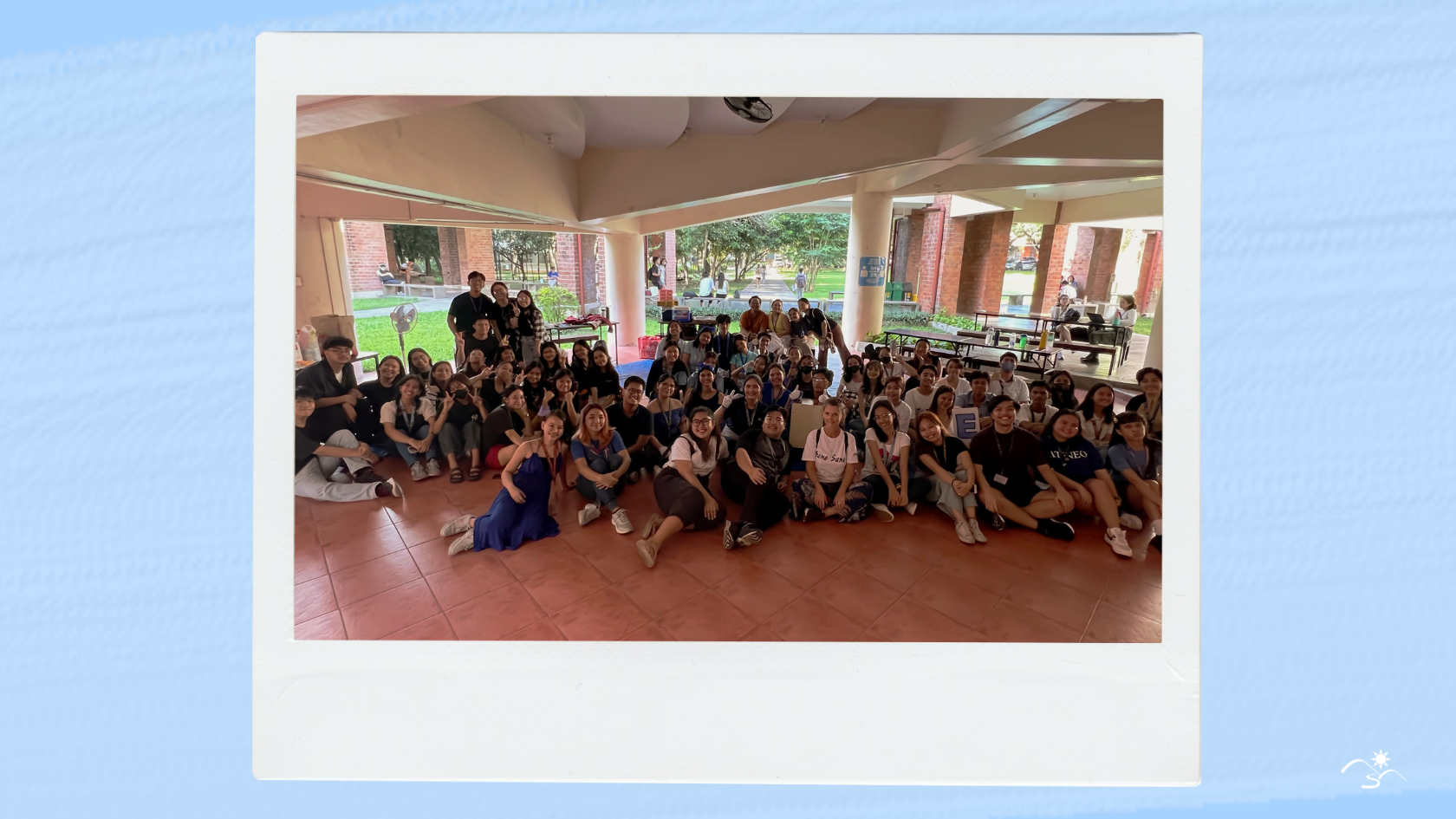 A Polaroid-like photo that has a photo of multiple students and their volunteers in Ateneo's SEC Foyer.