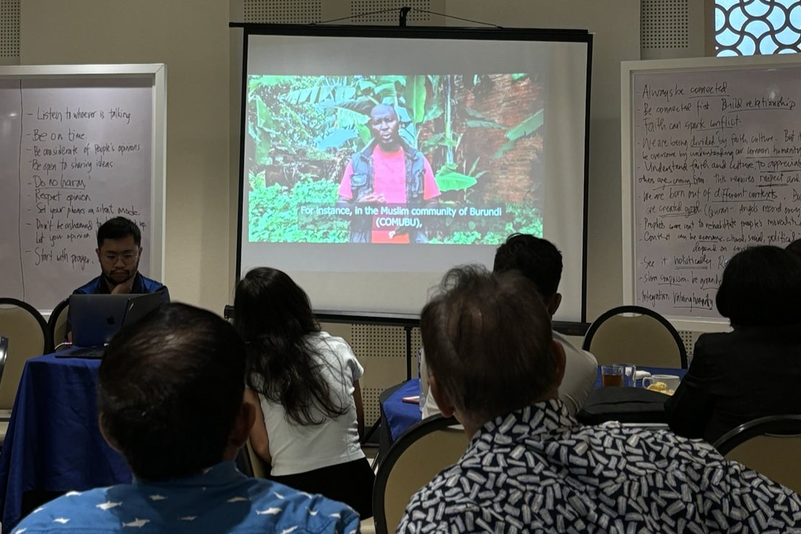 Workshop participants listen to videos from fellow members of the Hidden Peacebuilders Network in Burundi and Sri Lanka.