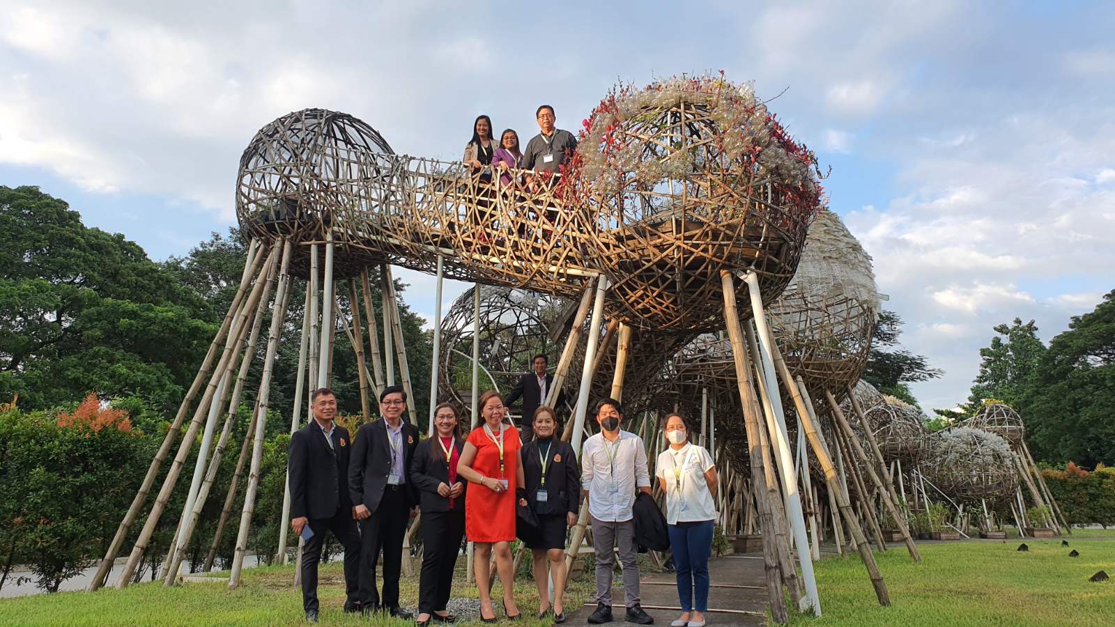 PATHWAY local partners pose against the outdoor installation of AAG titled “Mebuyan’s Colony” by Leeroy New, which is located at the Areté Amphitheatre.