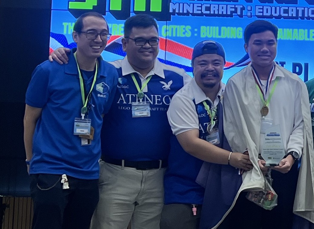 (L-R) Coaches Joel Falgui, Jason Arias, and Lavi Subang with Liam Daga onstage after Daga received his champion trophy  
