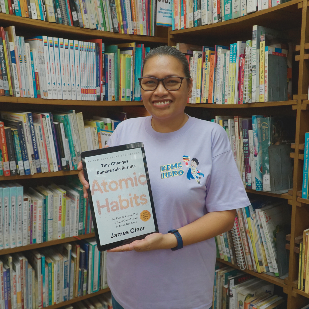 Pamela Albania poses with a copy of Atomic Habits