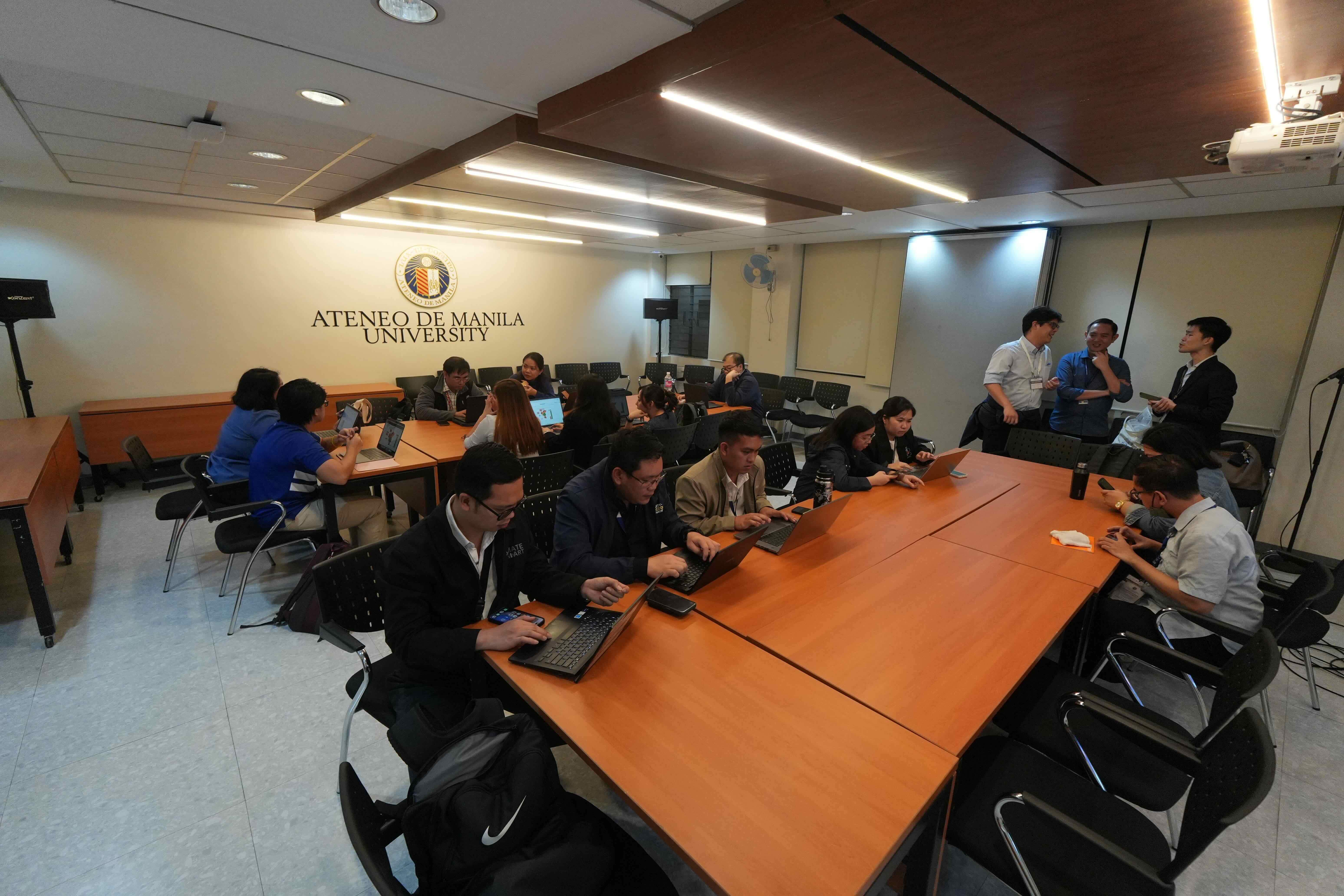 Breakout groups assigned to the NGF Room collaborate on the assigned material for workshop 2