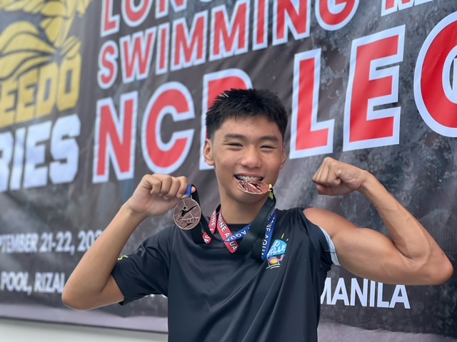 Tylo Alcudia with his medals from the Speedo Swim Meet  