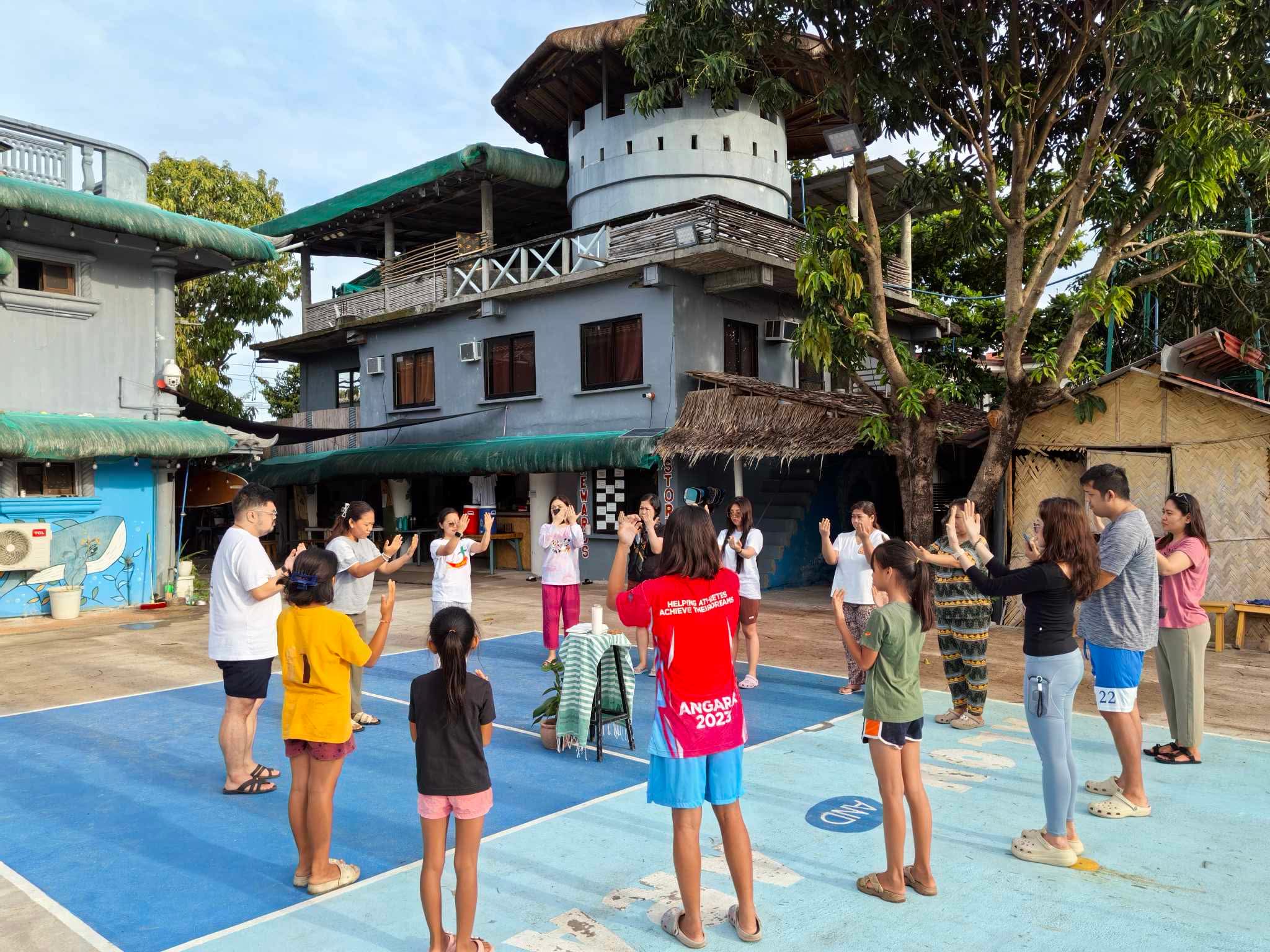 AJHS faculty and staff in prayer and 'oneing' with Mother Earth