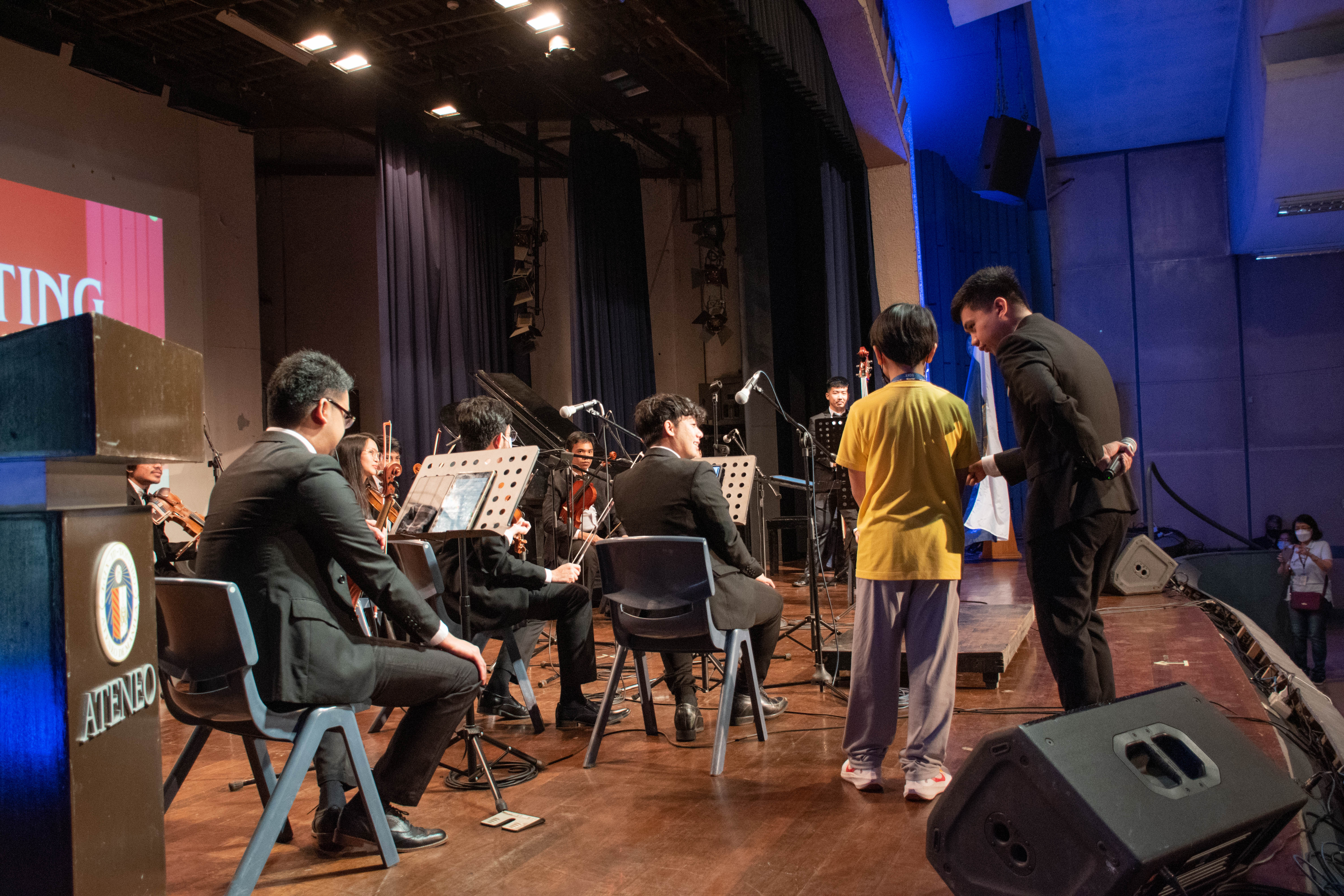 A Grade 5 boy tries his hand at conducting  