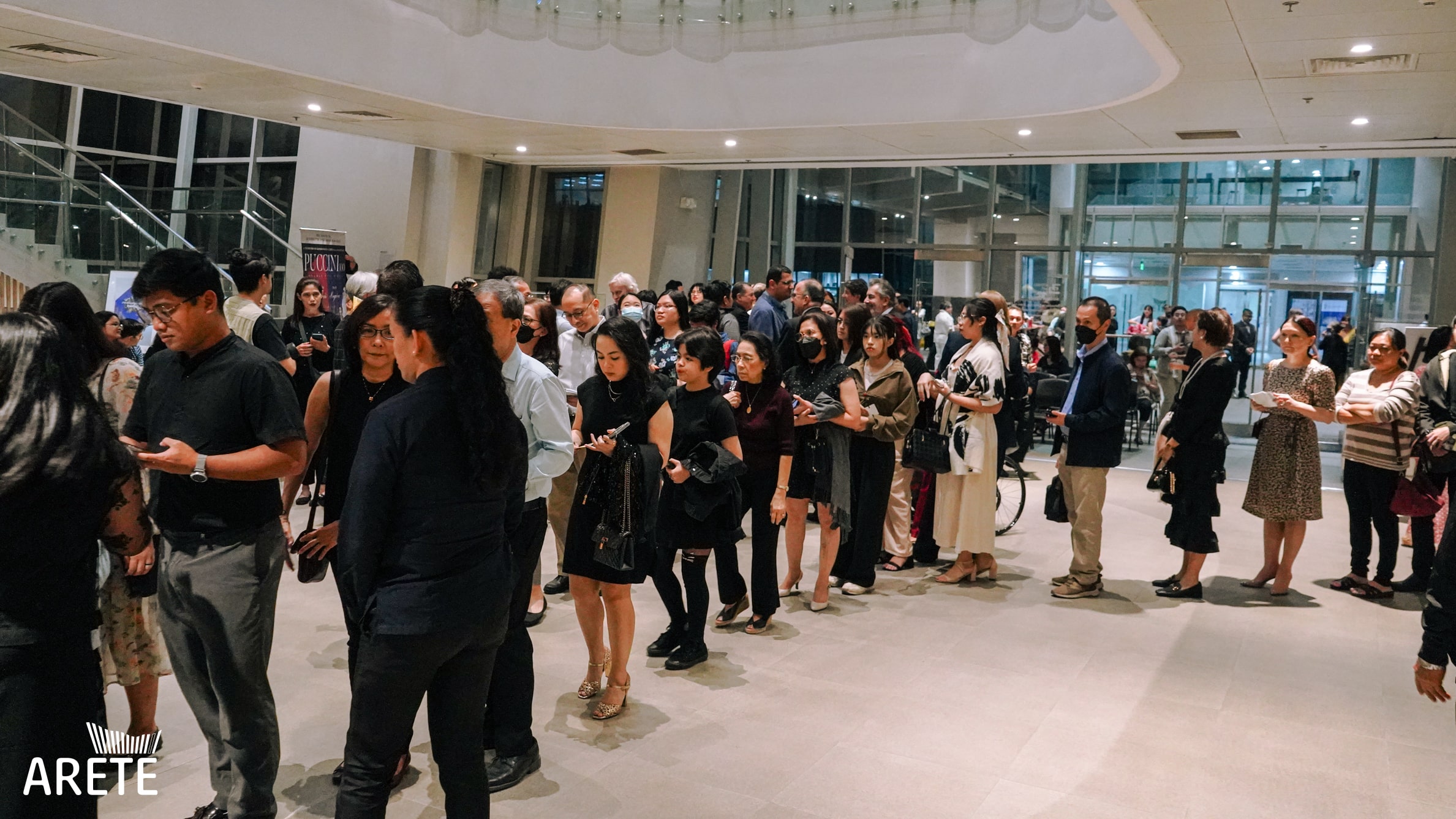 Attendees of Puccini at 100 line up to enter Areté's Hyundai Hall