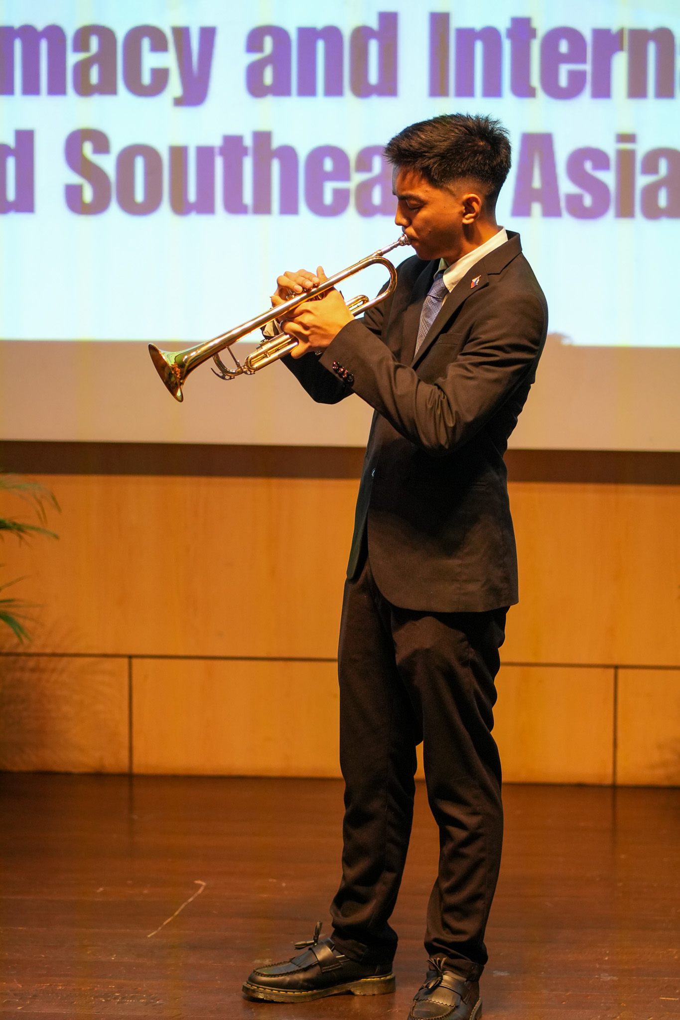 4th-year AB Diplomacy and International Relations, Conn David Gumanoy, performs his trumpet solo