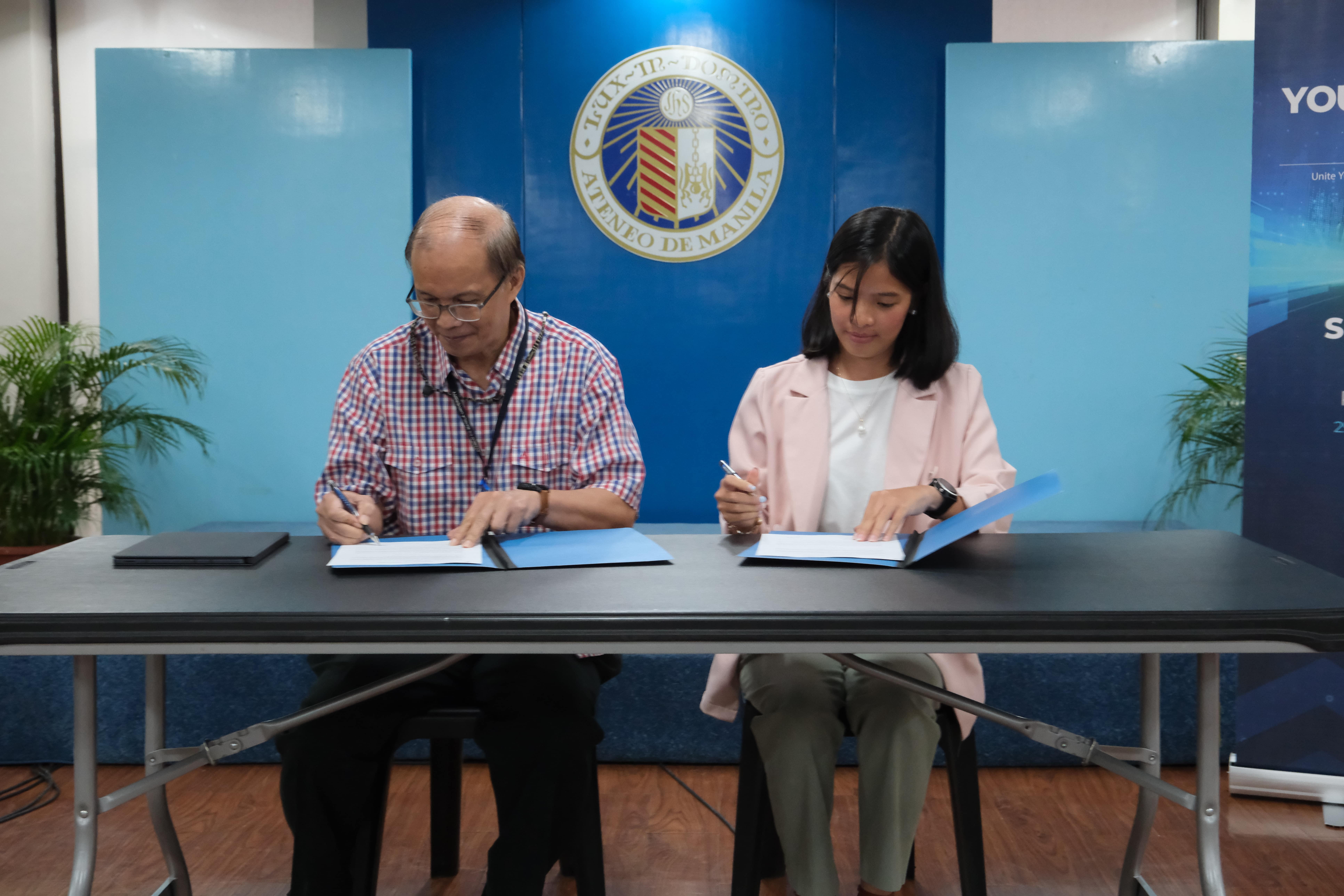 Engr Benjamin Mirasol (left) and Ms Fatima Malate (right) sign the MOU between the Ateneo Intellectual Property Office and Reactor School