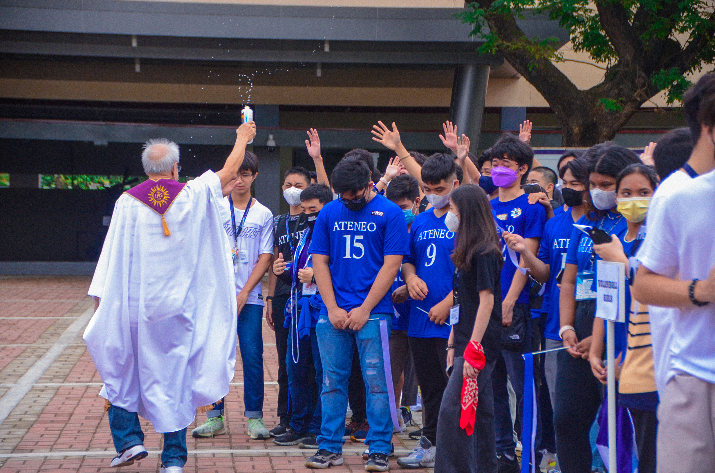 Fr. Ruben Reyes SJ blesses the athletes 