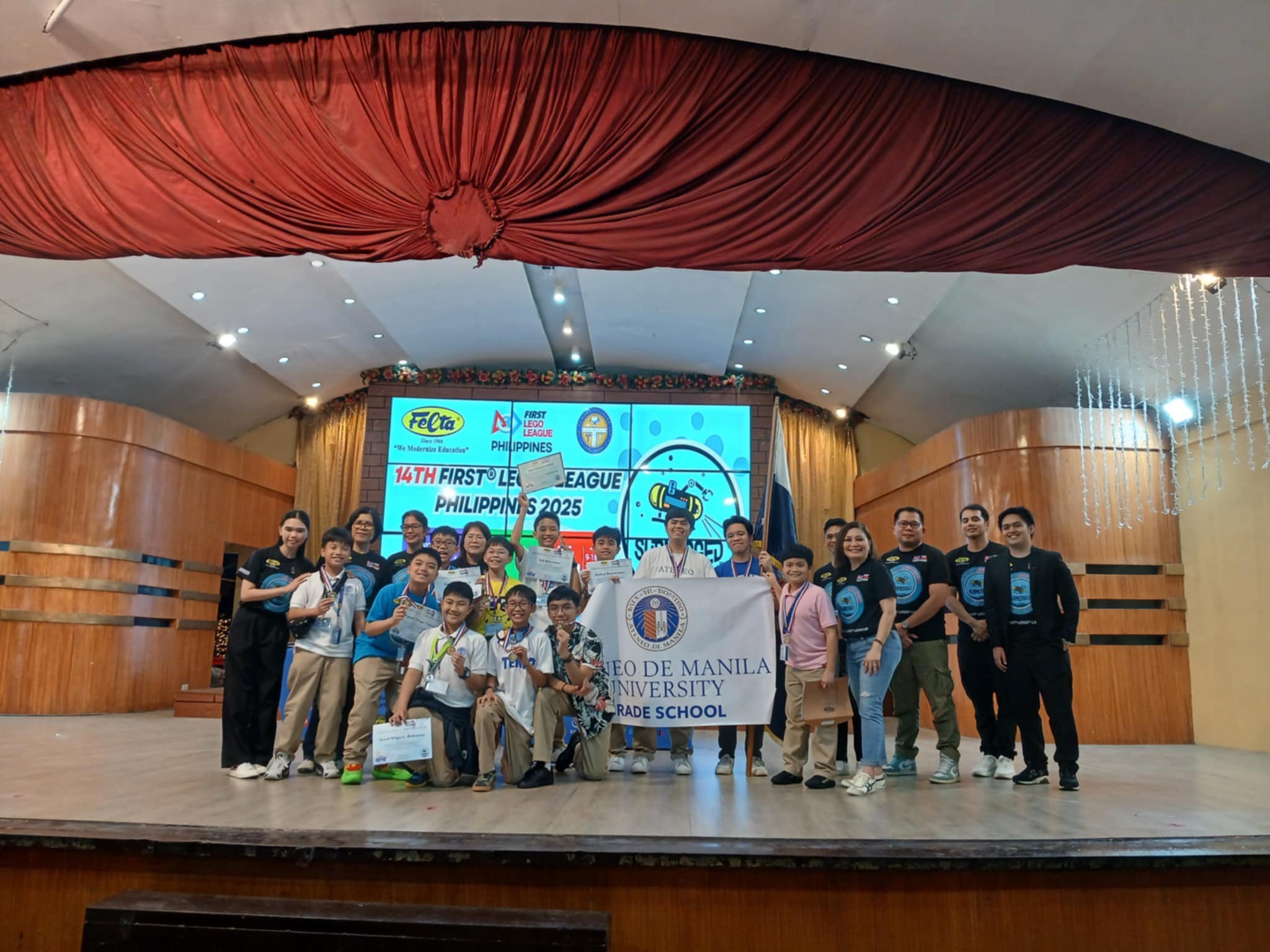 Winning moment: The members of AGS’ first ever robotics varsity team onstage with Felta officials to receive their gold medals as Best Rookie Team of the 14th FLL Philippines