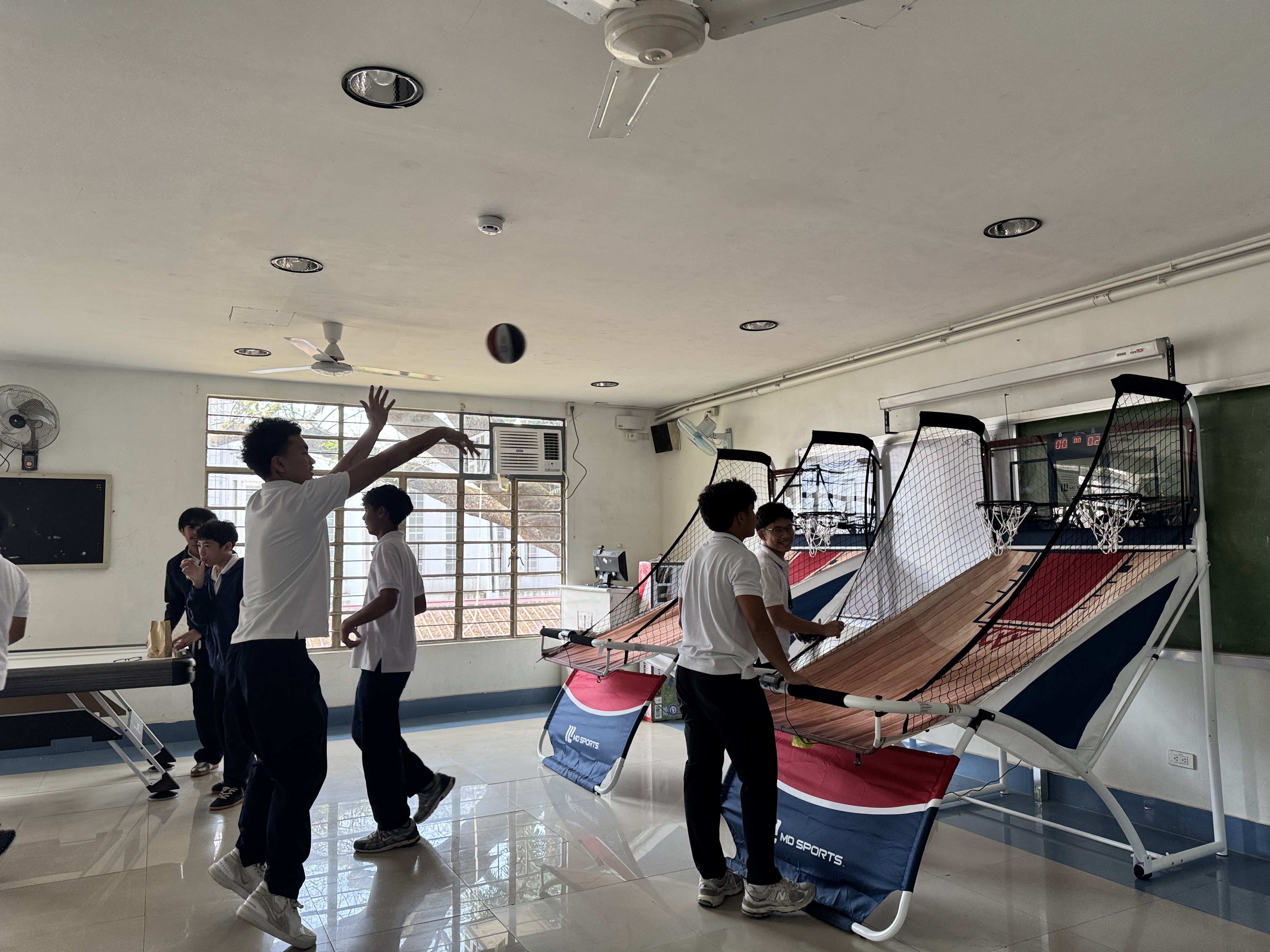 Students enjoying the basketball hoops during their break