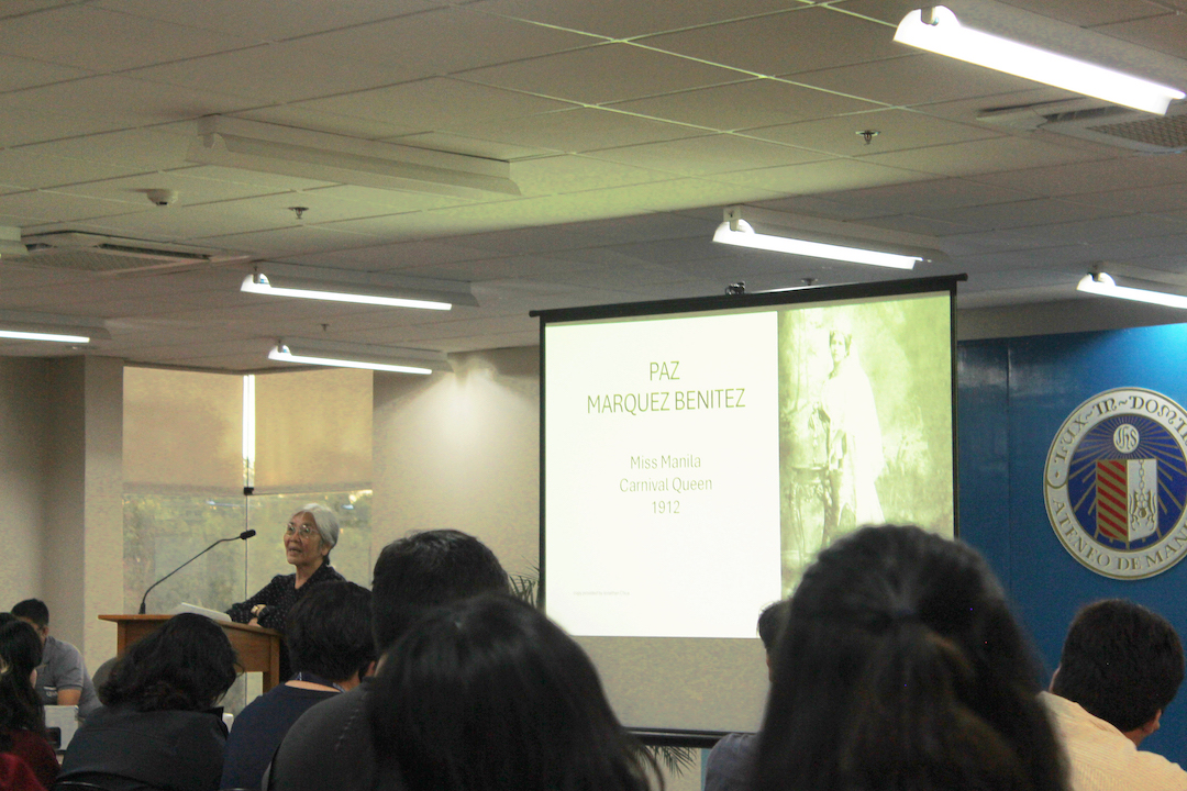 Dr Lucero in front of her slides on Paz Marquez Benitez