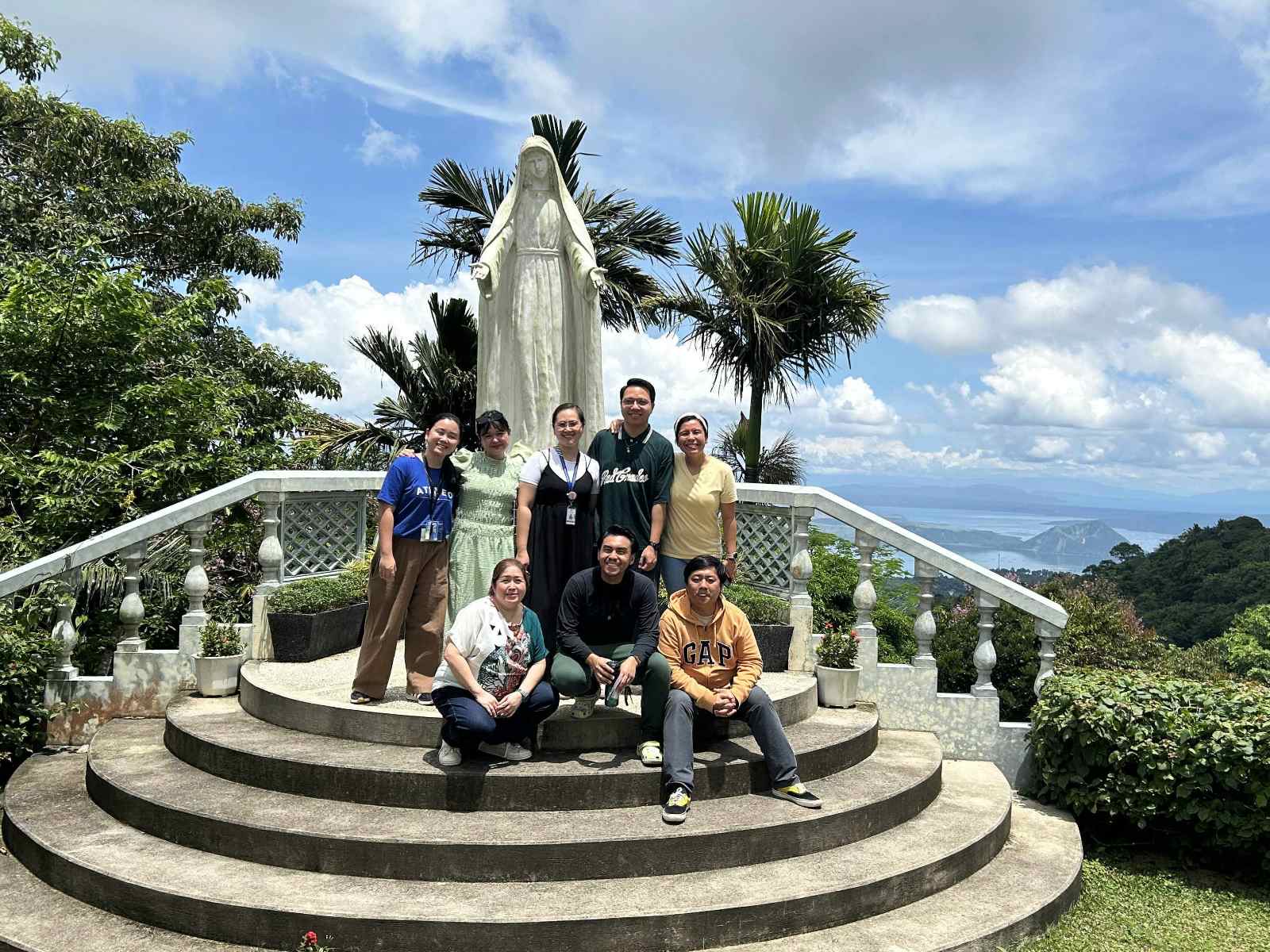 The author (top row, in yellow) with fellow retreatants from the English Subject Area in front of the image of the Blessed Mother after completing their 3-day retreat