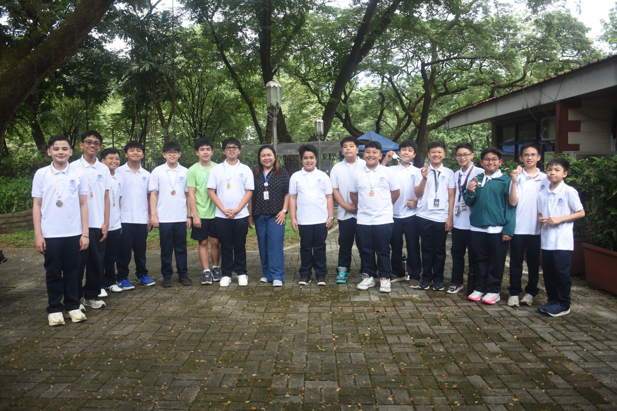 Many of the AGS mathletes who competed in the Primary 6 division last April are now in AJHS.  From left: Hunter White, Raf Zorilla, Austin Saulong, Rav Vergara, Lucas Sy, Lucas Clariza, Shun Sato, Mrs Gen Sanvictores (AJHS Principal), Arvie Gelbolingo, A.K. Telan, Fons Mangabat, Mateo Palitog, Russ de Belen, Zio Baking, Marcus Salom, Ramon Pagaduan, Zack Copuyoc   