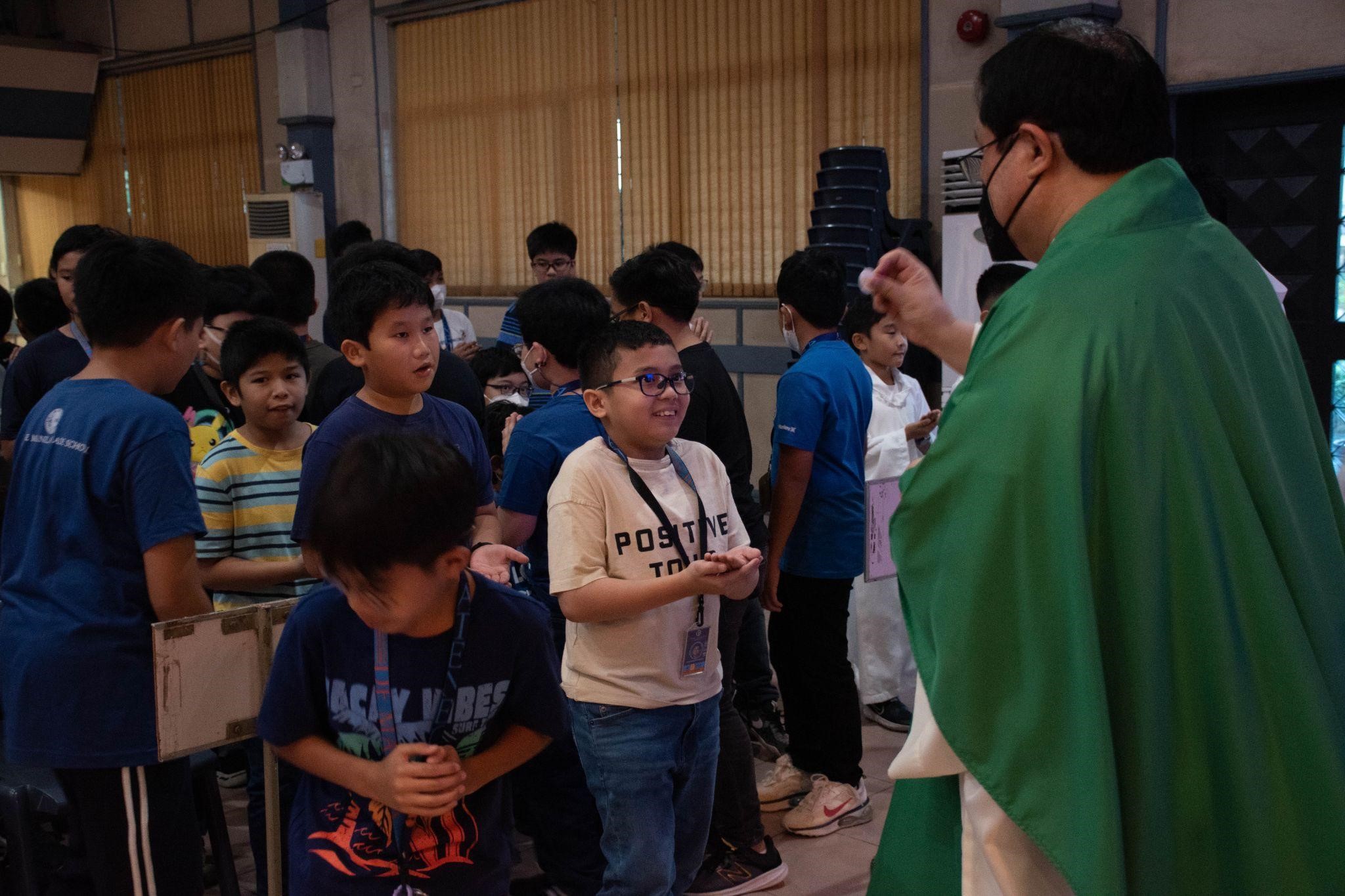 Spiritual nourishment: Grade 5 boys receive the Holy Eucharist