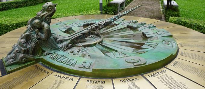 Saint Aloysius Gonzaga kneeling and surrounded by objects that are commonly attributed to him