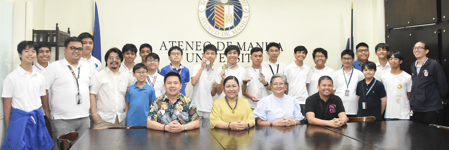 Members and coaches of the AJHS BlueBLOC varsity team with AJHS administrators (seated)  