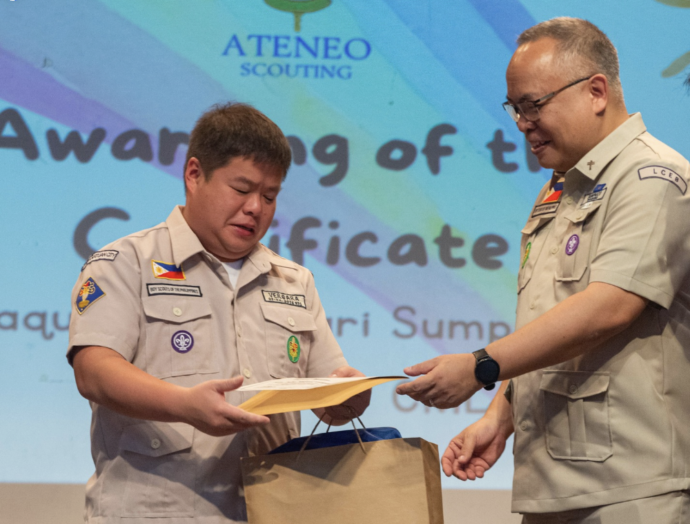 Fr Jonjee Sumpaico SJ (right) presents a token of appreciation to Scouter Vergara for inspiring our young scouts