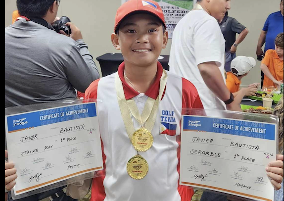 Javie Bautista in Guam wearing his two gold medals 