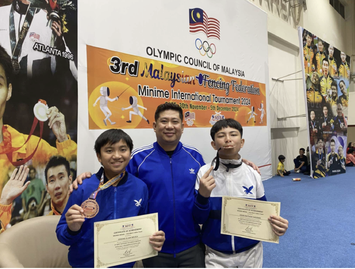 (L-R) Eliam Mojica, Coach Edward Daliva, Aiden Taguinod 