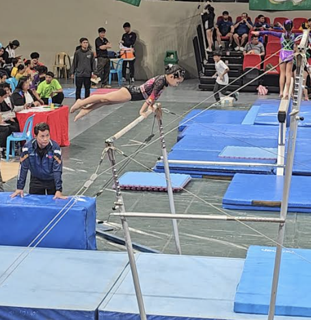 Autumn Orallo on the uneven bars 