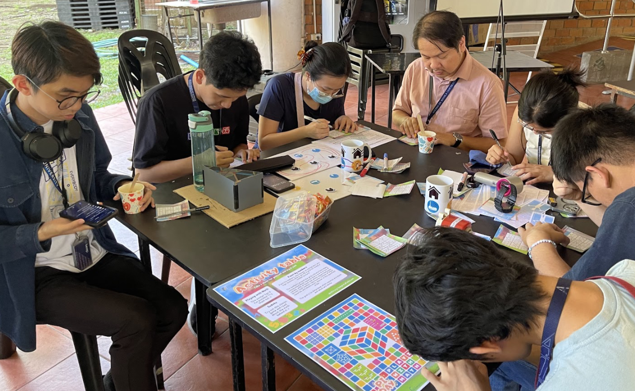 pi-day attendees solving different puzzles at the activity table