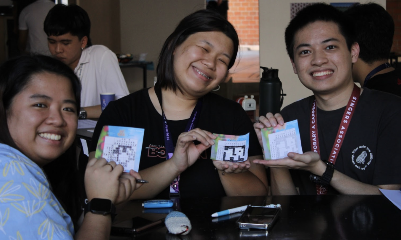 Students showing off their puzzles from the activity table