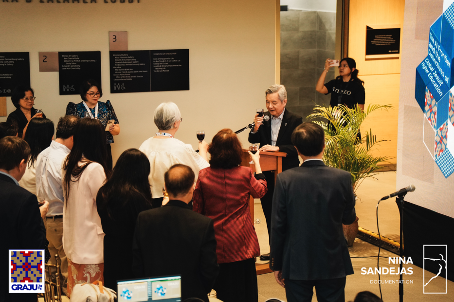 Fr Bobby Yap SJ shares a toast with the participants