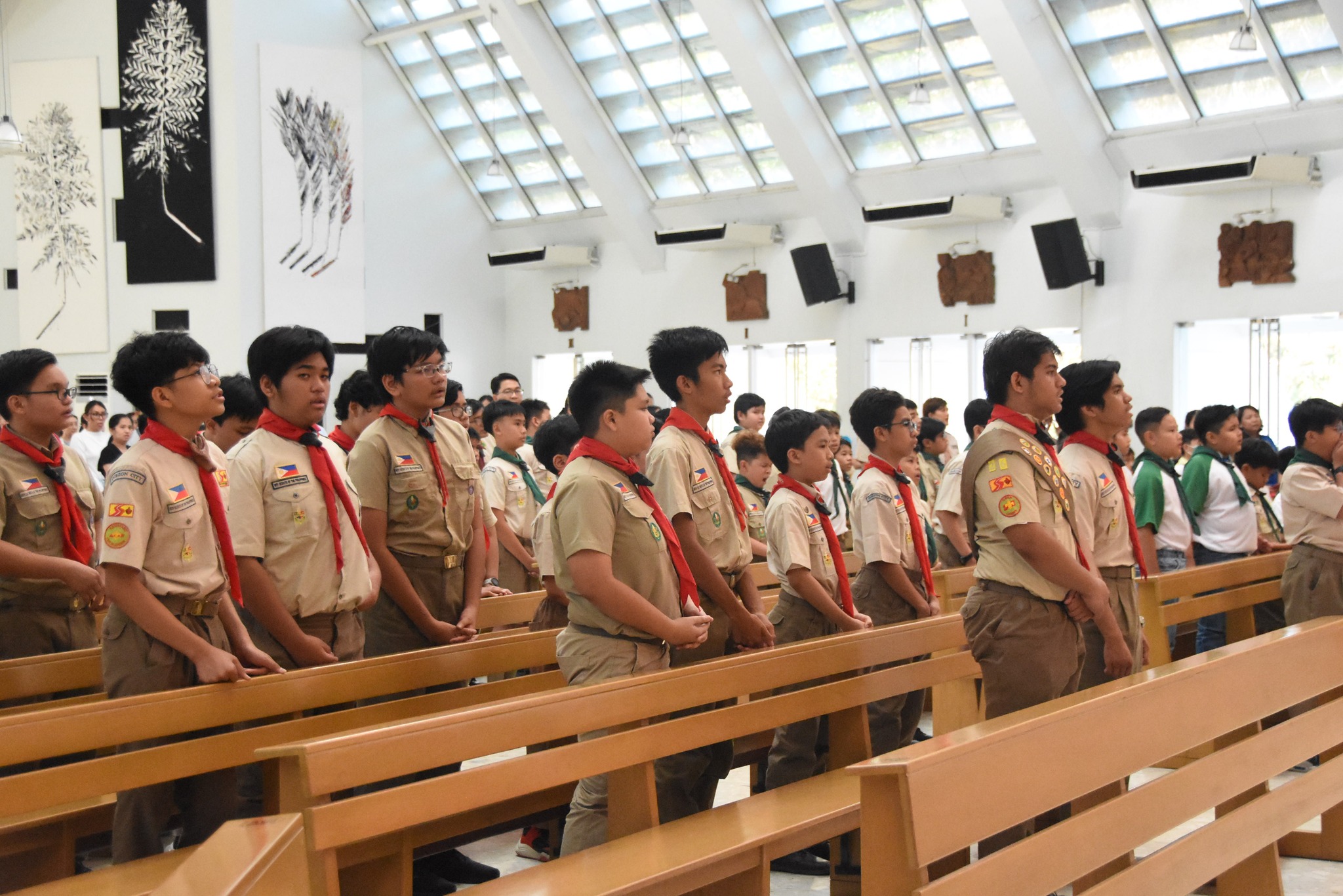 The Senior Scouts stand out with their red neckerchiefs, which symbolize their experience and leadership