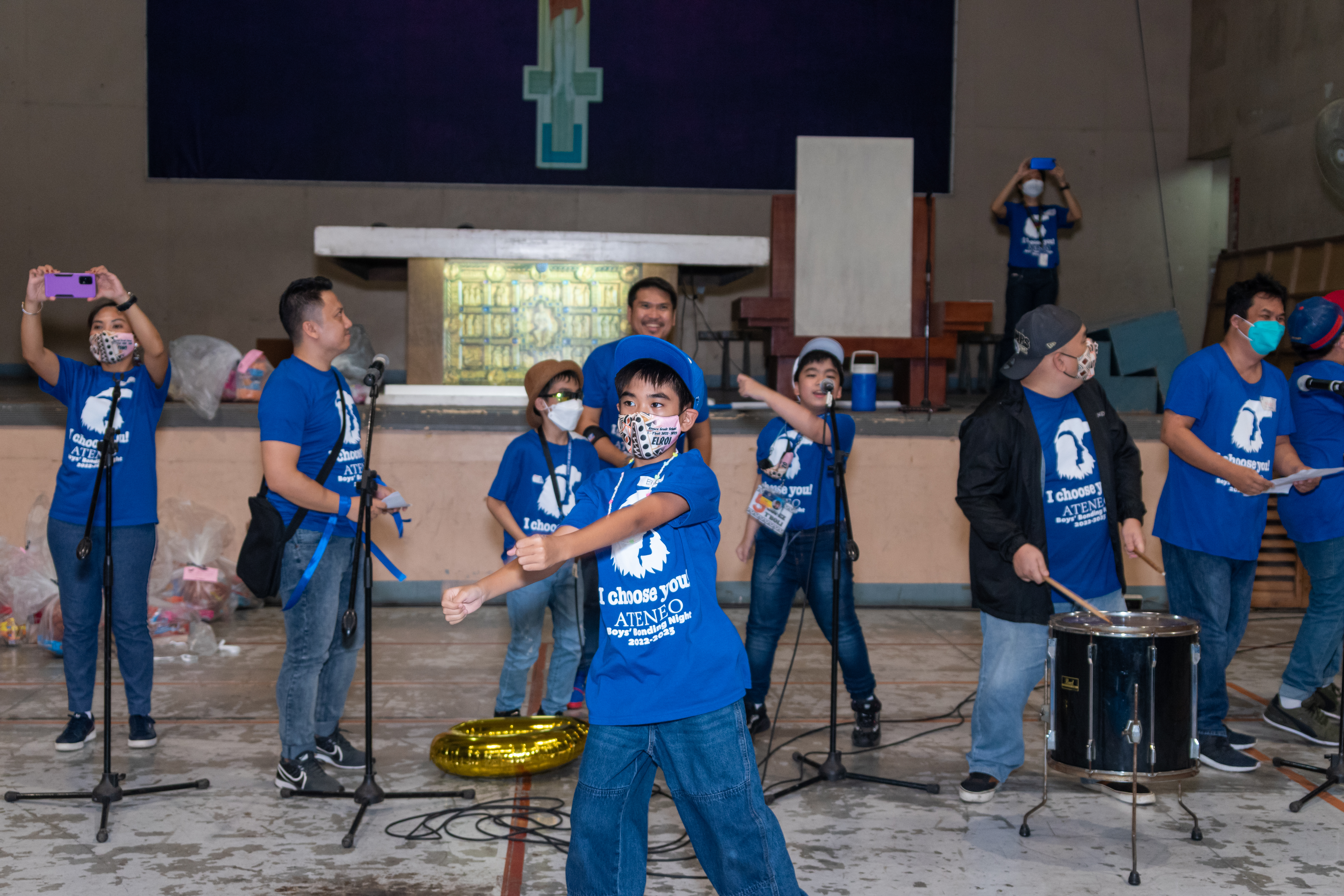 Fathers and sons leading their team cheer with all their might!