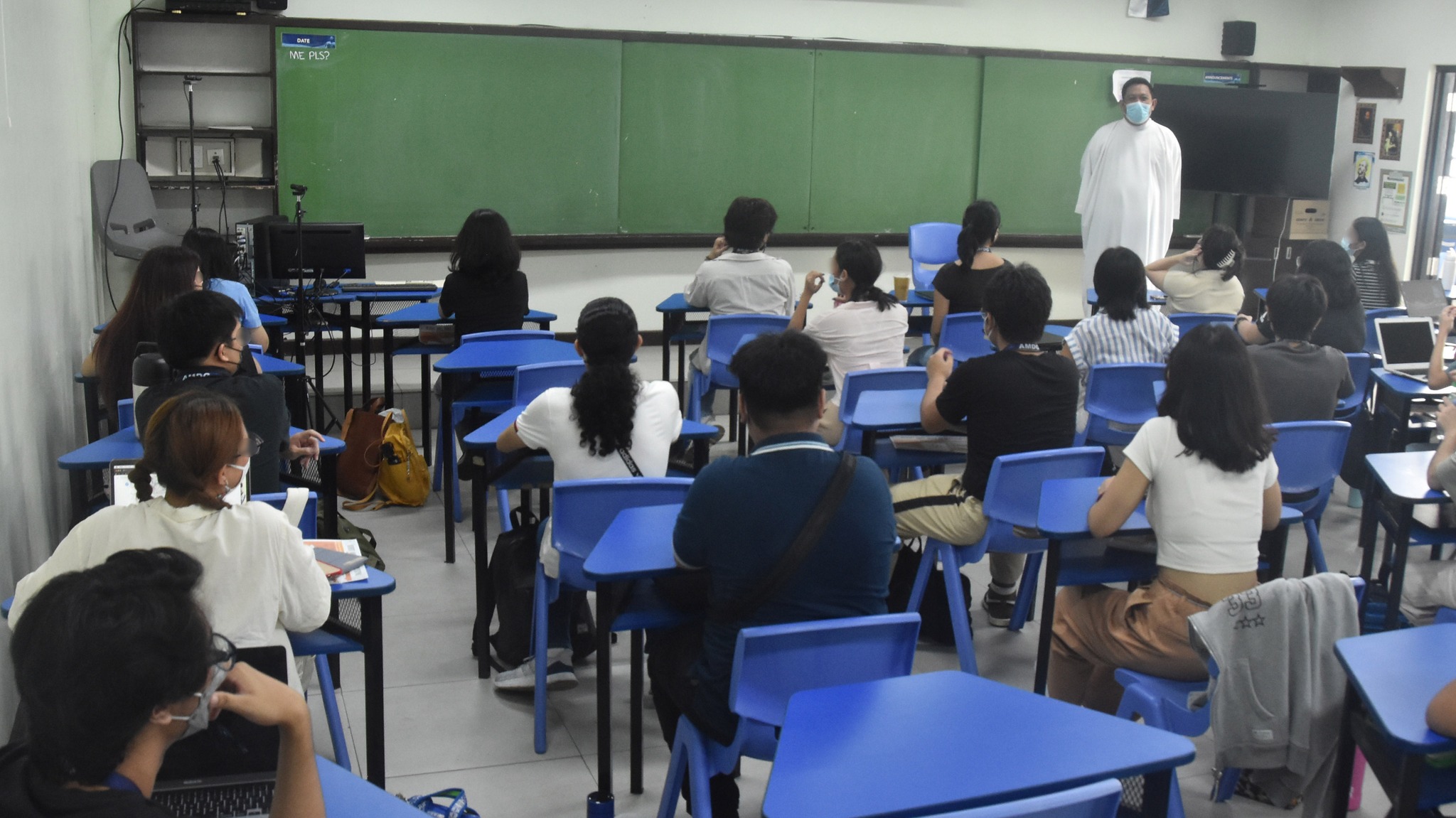 Fr. Bong Dahunan SJ (right) visits a Grade 12 class