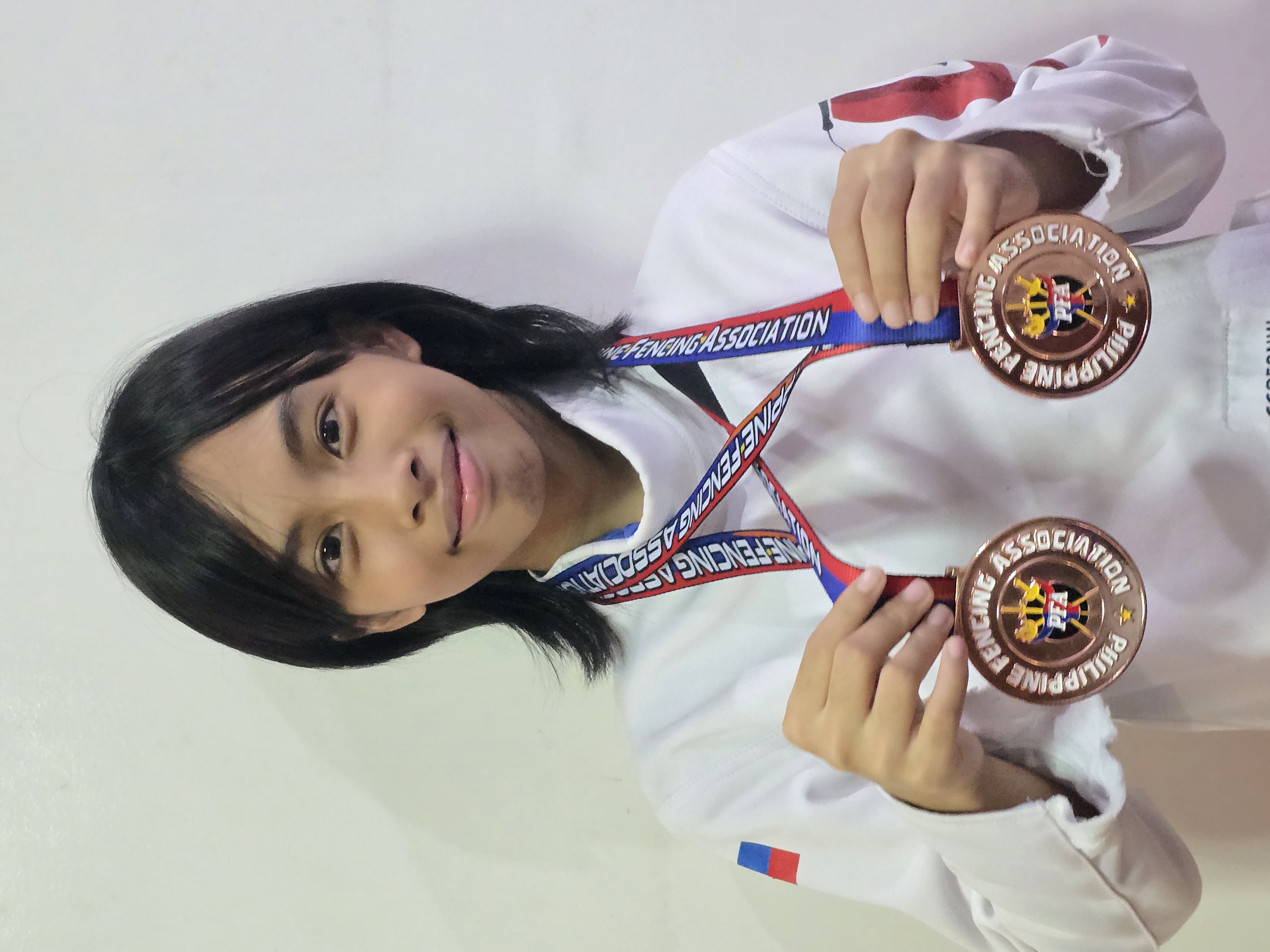 Jowie Cabaccan with her two bronze medals from the Minime competition