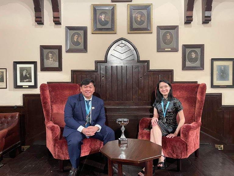 Anton Abiera & Naomi Ang with their trophy in the historic Cambridge Union building