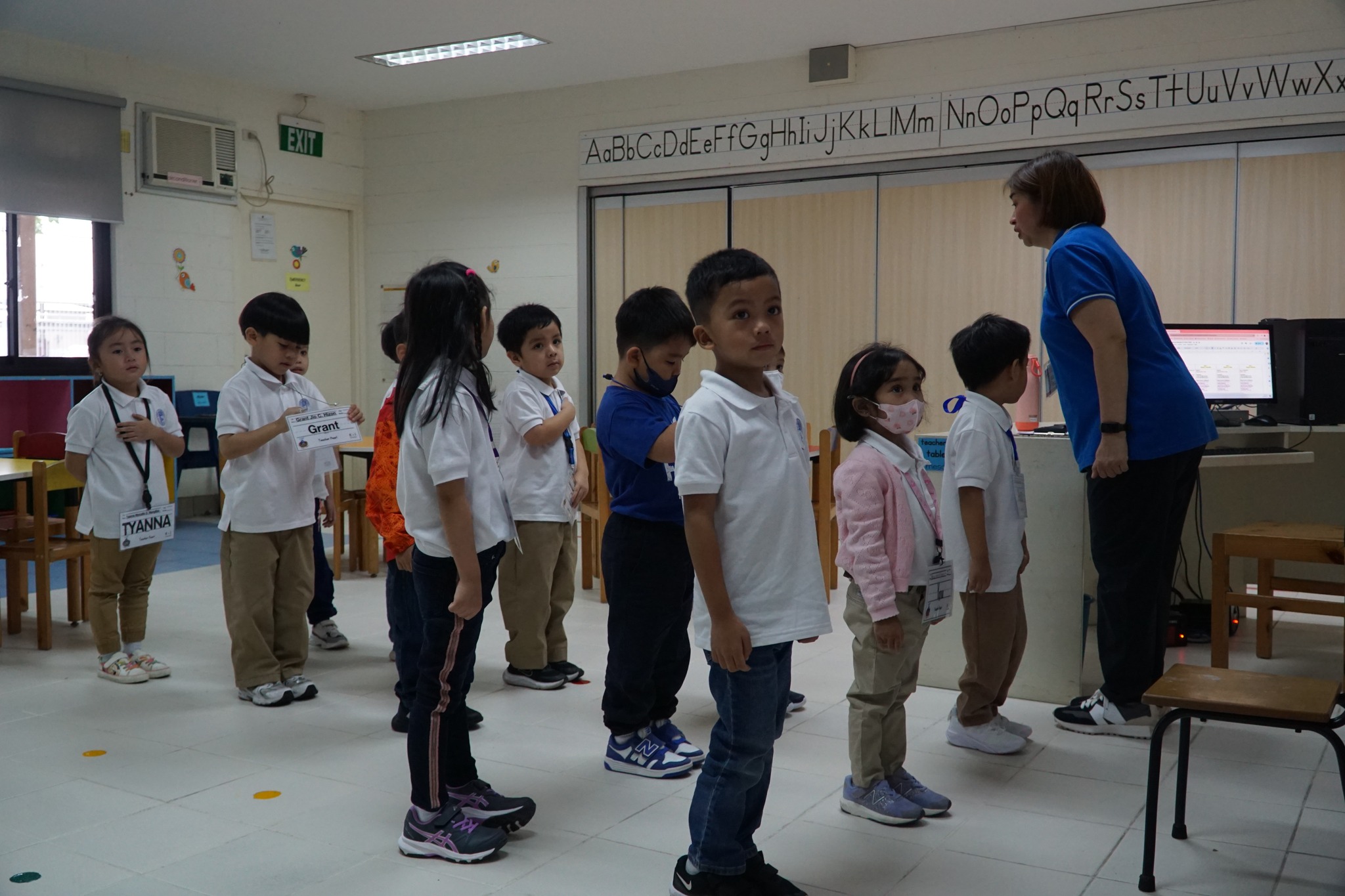 Kinder students waiting for the flag ceremony to begin 
