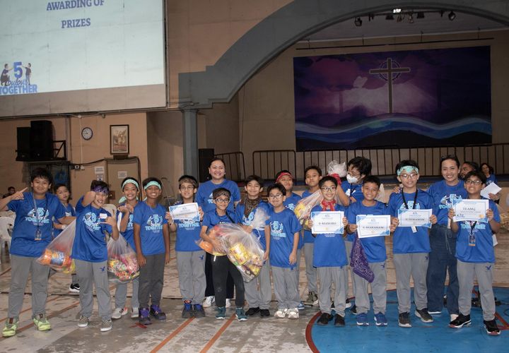 Happy section representatives claiming their class’ team prizes