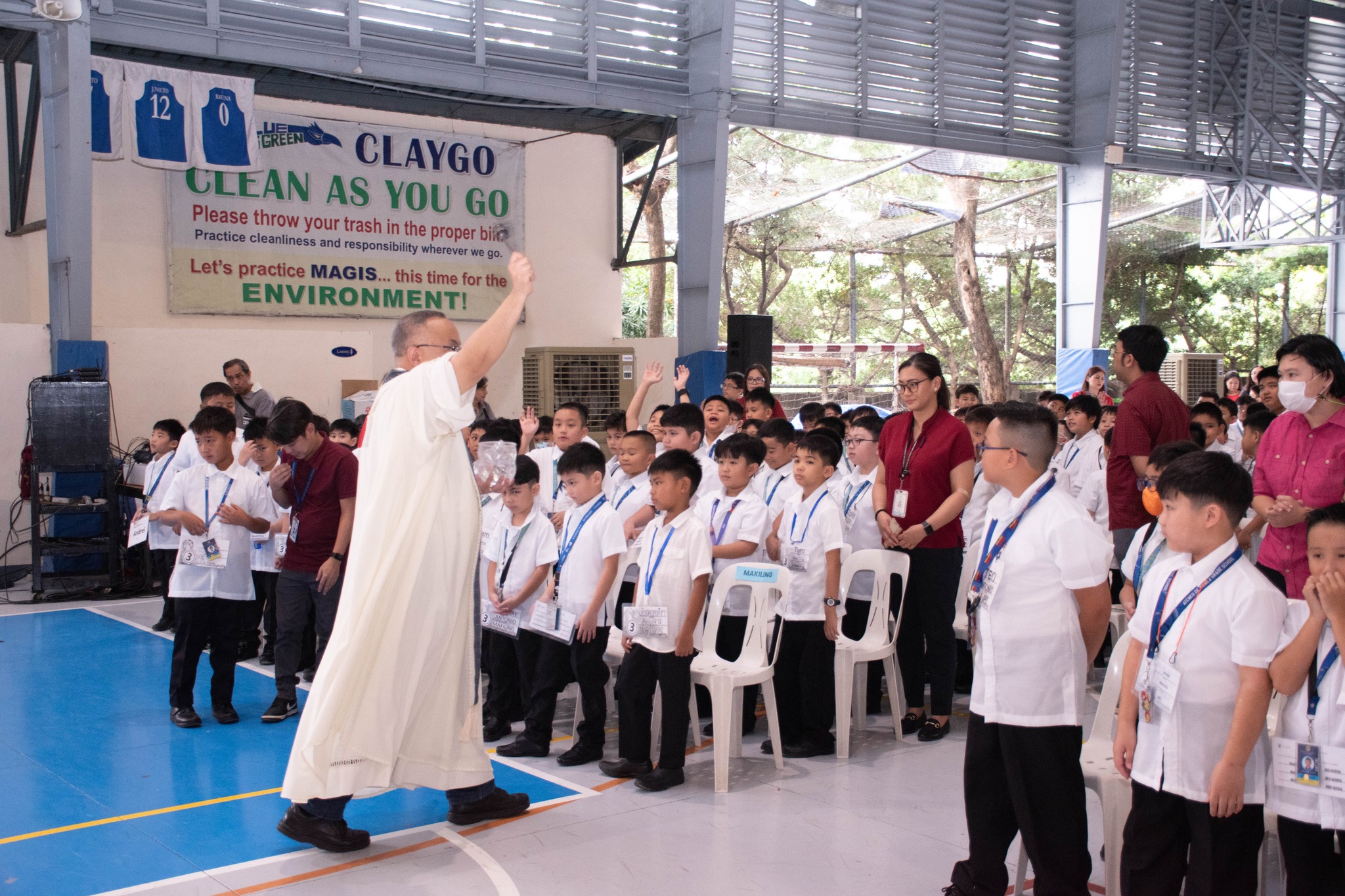 Students, teachers, and staff receive a blessing with holy water at the close of the celebration.