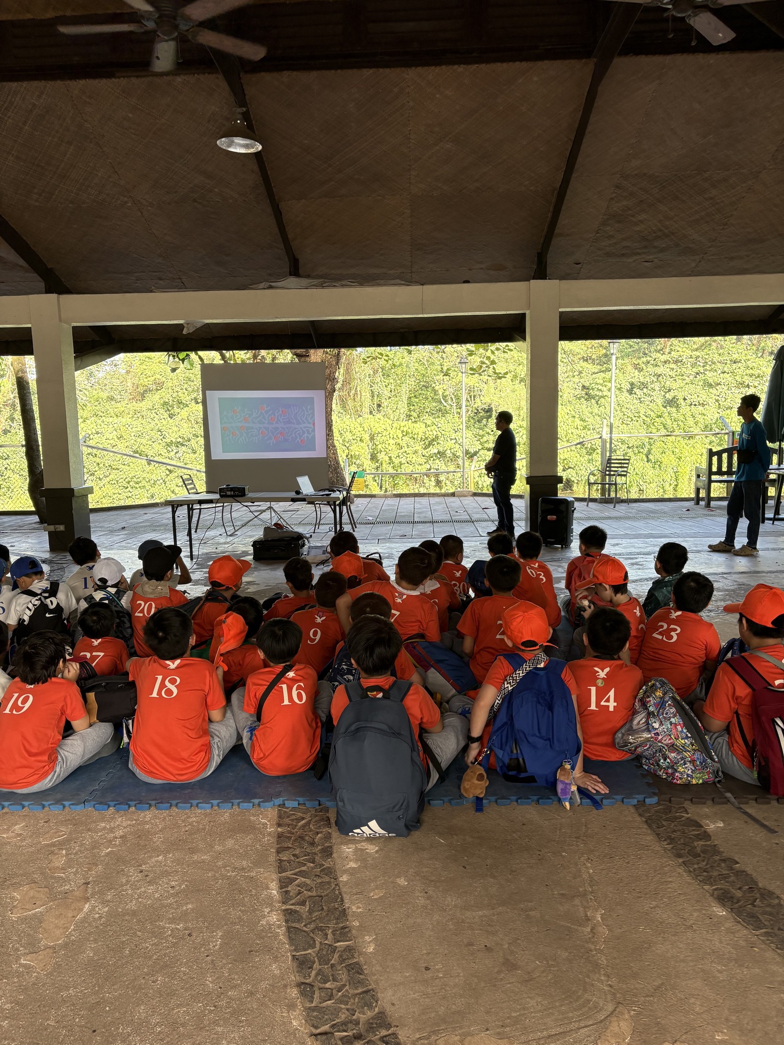 The students listen attentively as they learn more about recycling water
