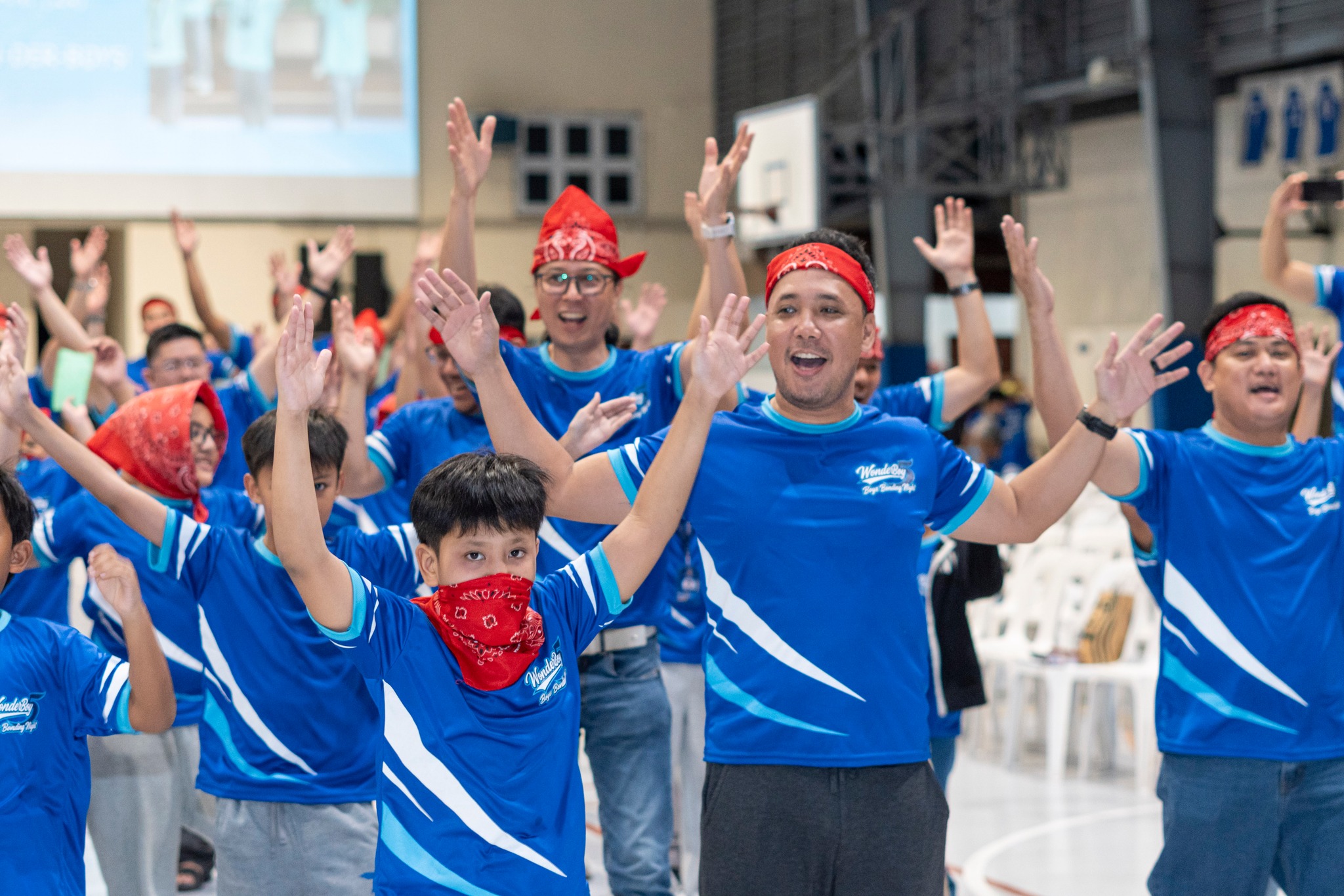 Adults and the young ones move in spirited unison during cheers