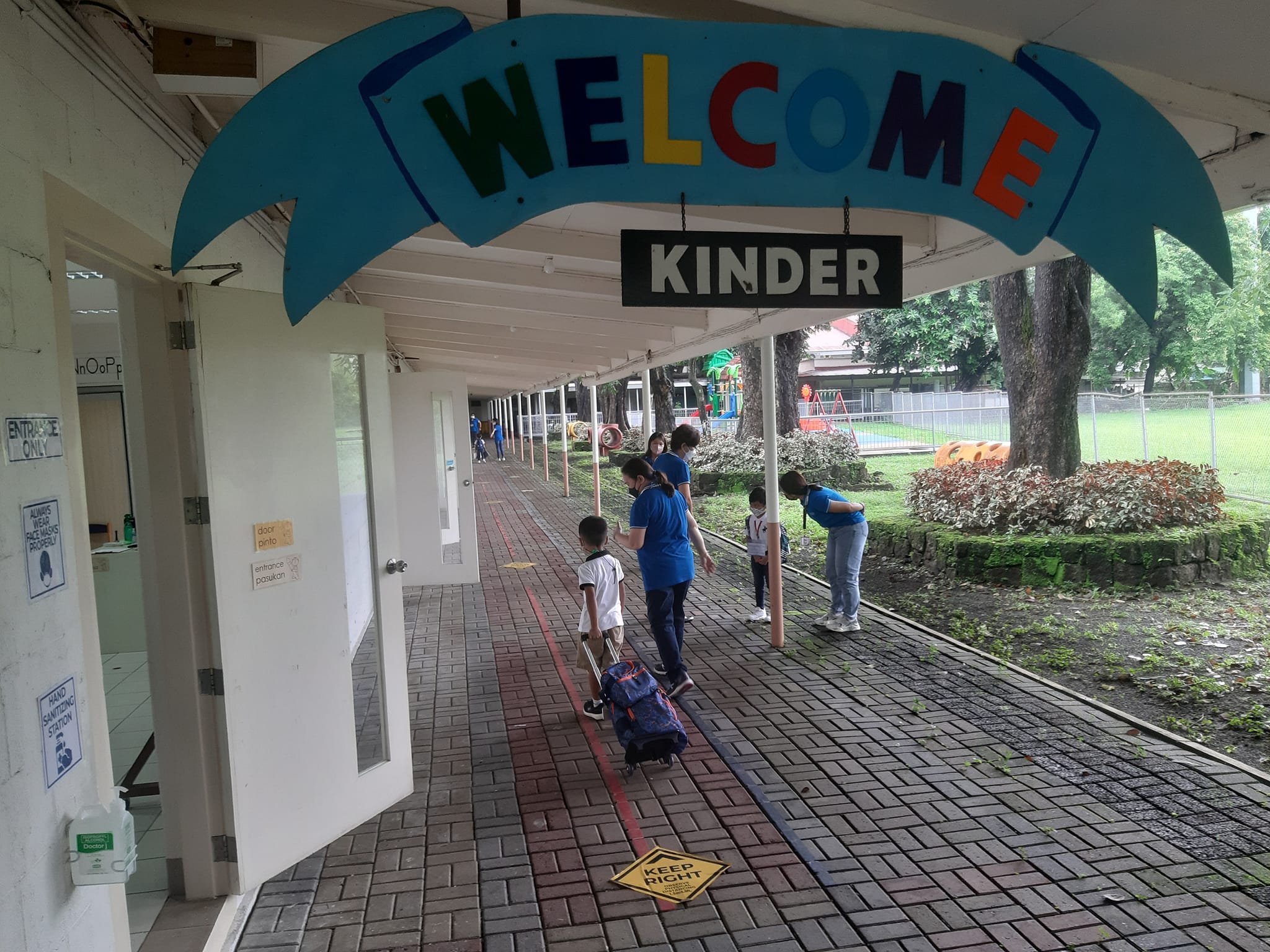 Kinder boys being led to their classrooms