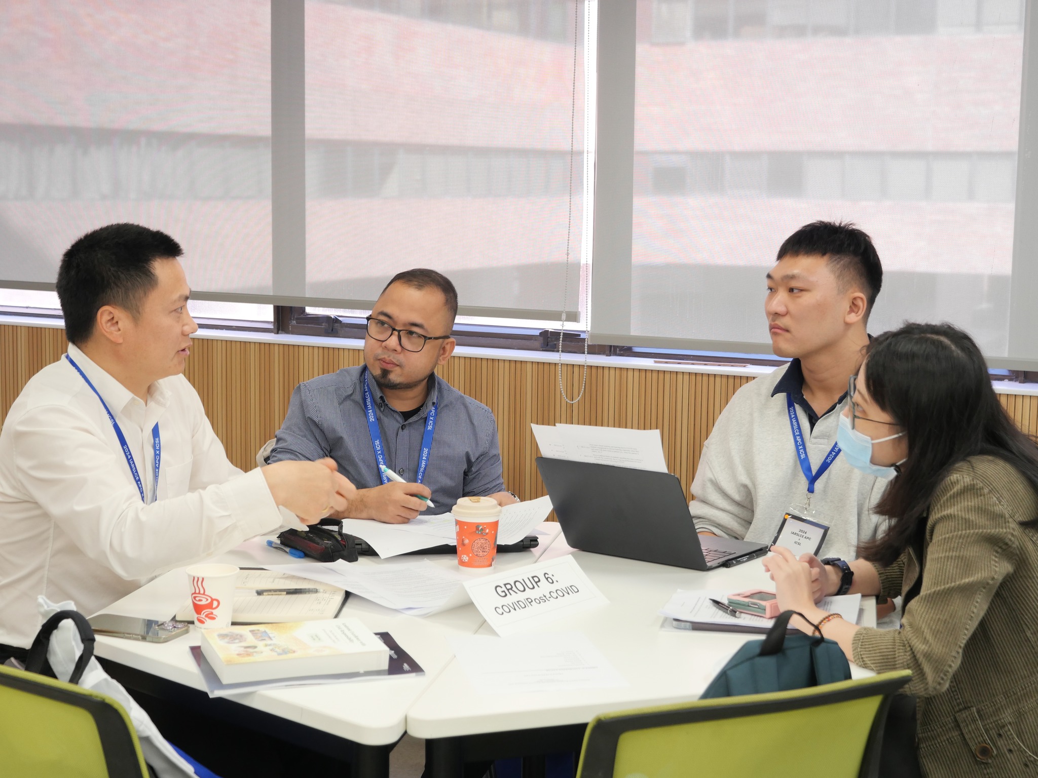 Mr. Jomell Caramancion (second from left) and his groupmates during the pre-conference session discussing the global research agenda.
