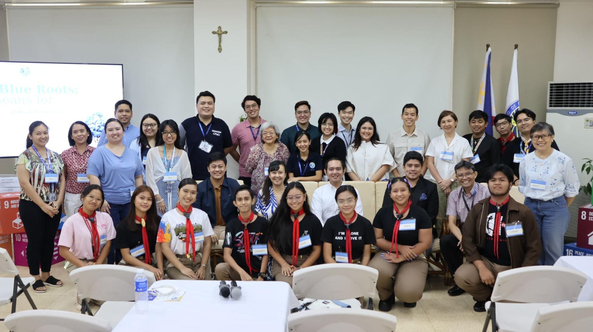Panelists, guests, colleagues, and members of the community partake in a group photo. Photo by AIS.