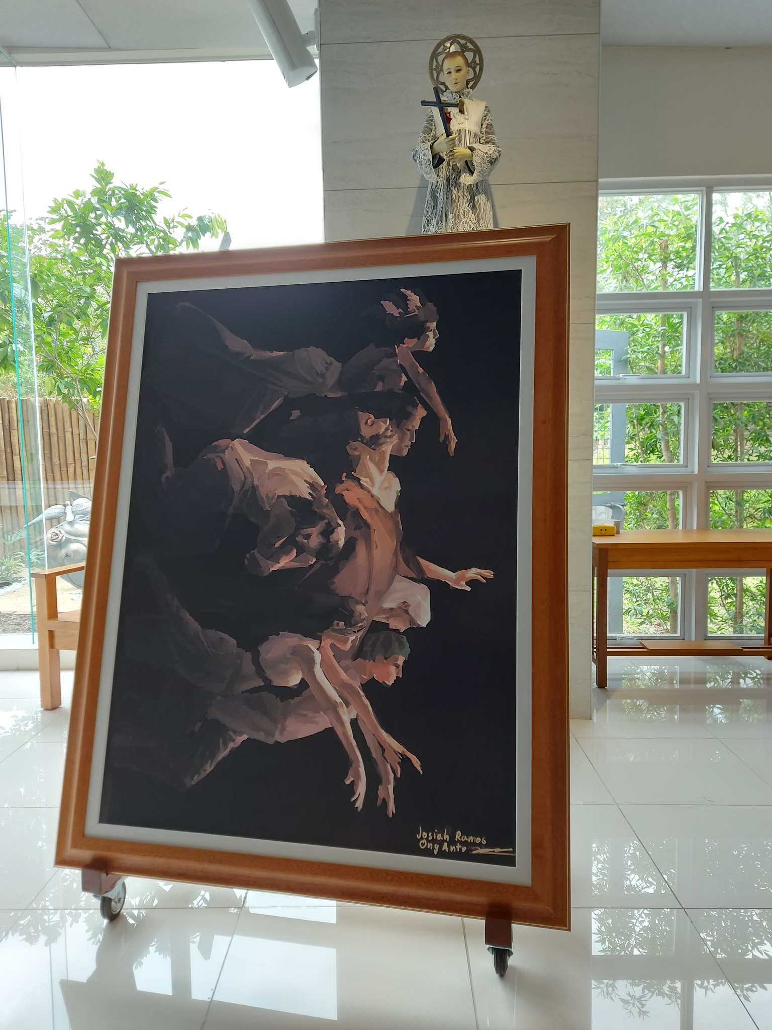 Josh Ong Ante's framed artwork under the watchful gaze of St Luigi Gonzaga in the ASHS Gonzaga Chapel