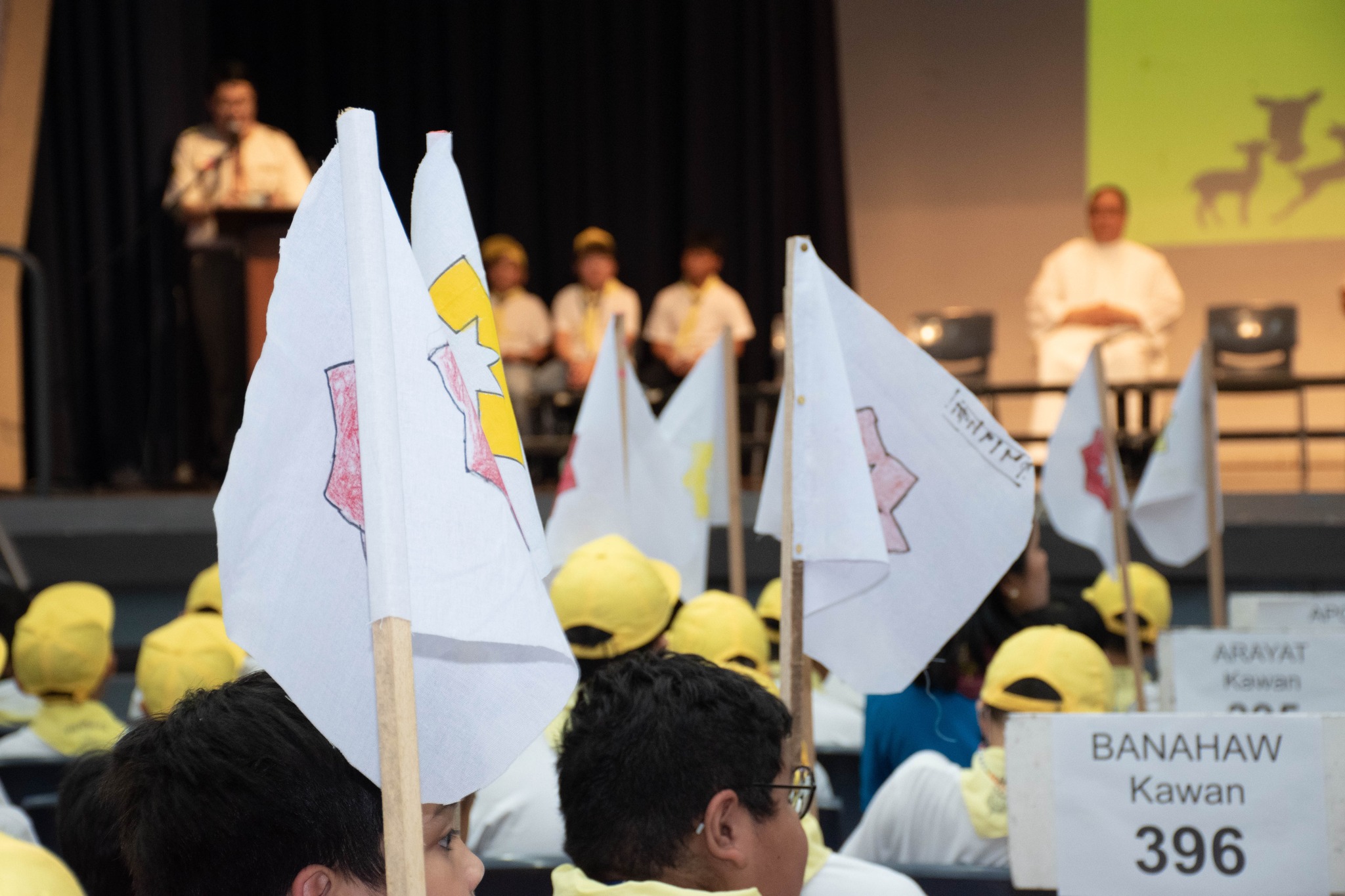 KAB Scouts proudly showcasing their flags during their Court of Honor ceremony