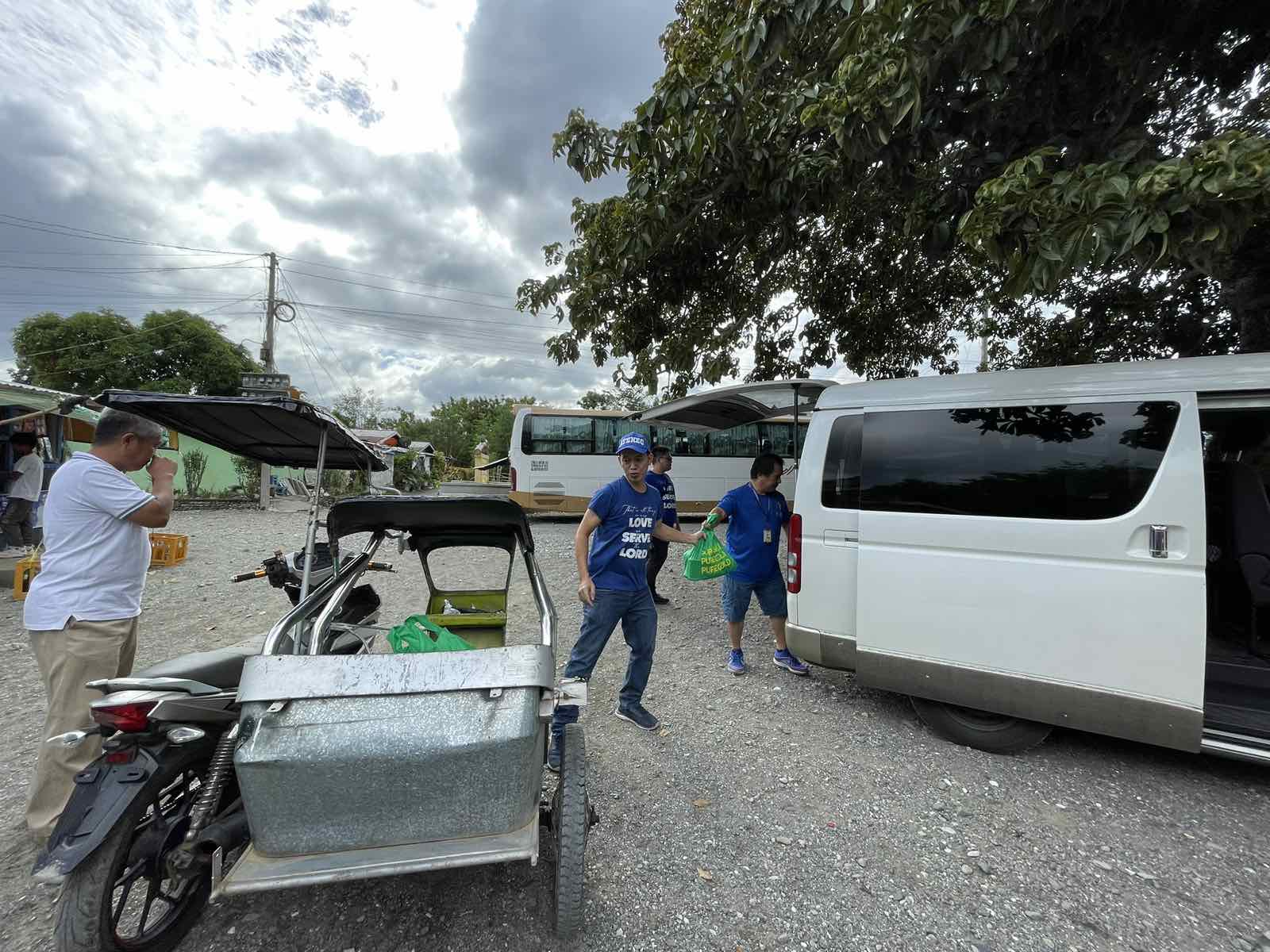 The Kinder family shares grocery packs with friends from Gawad Kalinga Village in Gabaldon