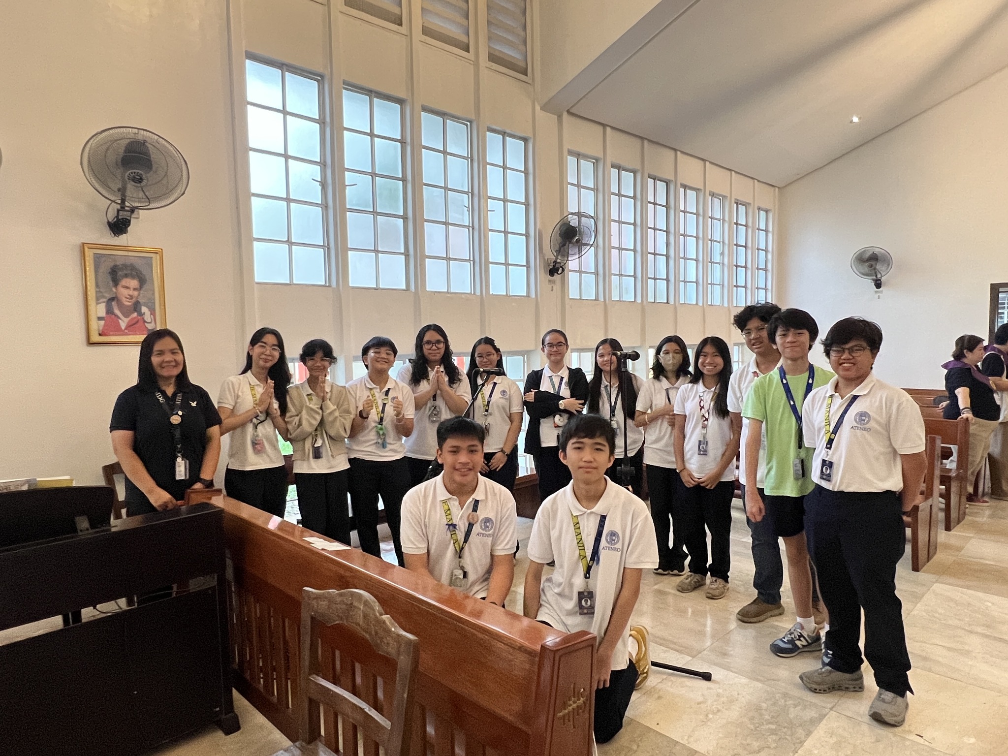 The Kostka Chapel Daily Mass Choir, together with their moderator Ms. Dianne De Guzman (first from the left), pose for posterity after the morning Mass.