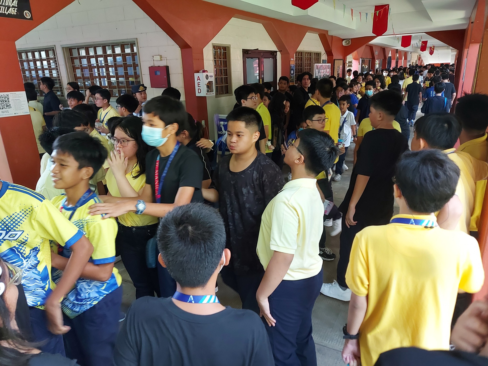 Students dressed in yellow and black shirts crowd both sides of the Edsa Walk during the activity