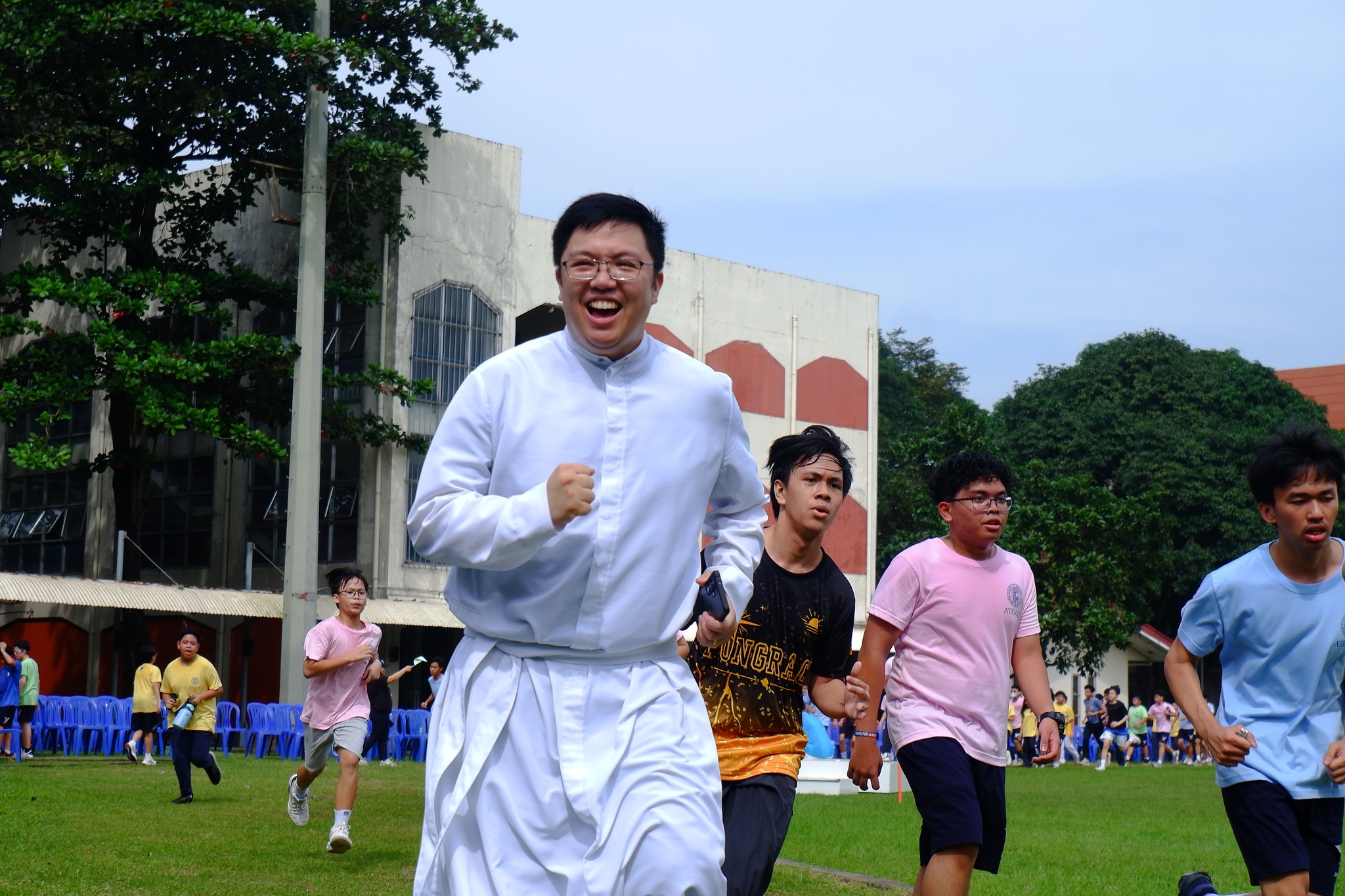 From the pulpit to the pavement! Rev. Bien Cruz, SJ, delivered the homily at the Kostka Mass and ran alongside the students the very next day during the Fun Run.