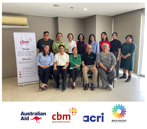 A formal, posed photo of the programme team. Eight individuals stand behind a row of five seated team members